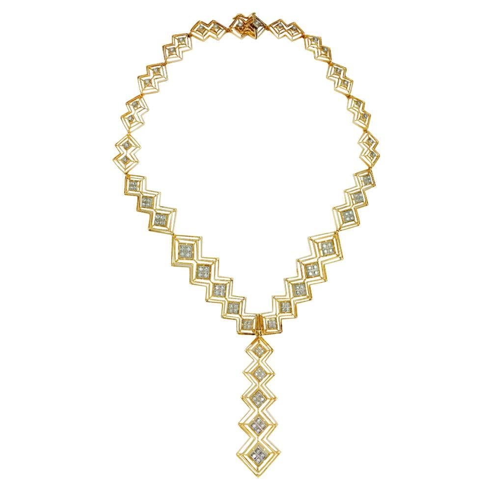 A 750/000 yellow gold Ilias Lalaounis tie necklace made with nine independent open-worked motifs. The motifs are made with two, three or five lozenge, centered with 750/000 white gold lozenge enhanced with one or four 8/8 cut diamonds. 
Diamond