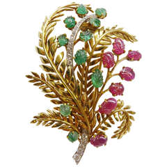 1950's Chaumet broach set with engraved rubies and emeralds.