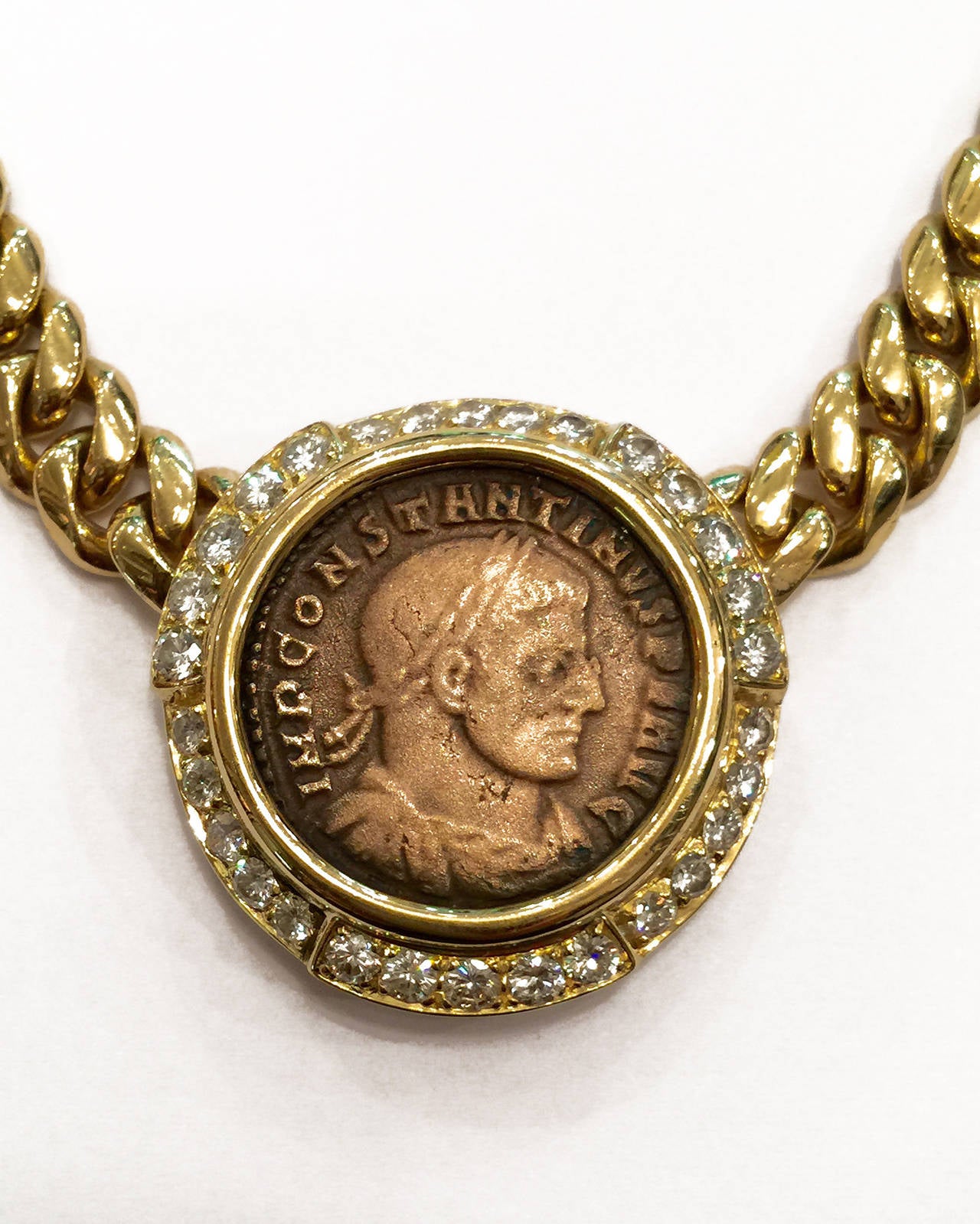 Yellow gold Bulgari necklace, in the center, a bronze coin surrounded with brilliant-cut diamonds. 
Weight : 86,7 grams.
Length : 420 mm 
Circa 1990