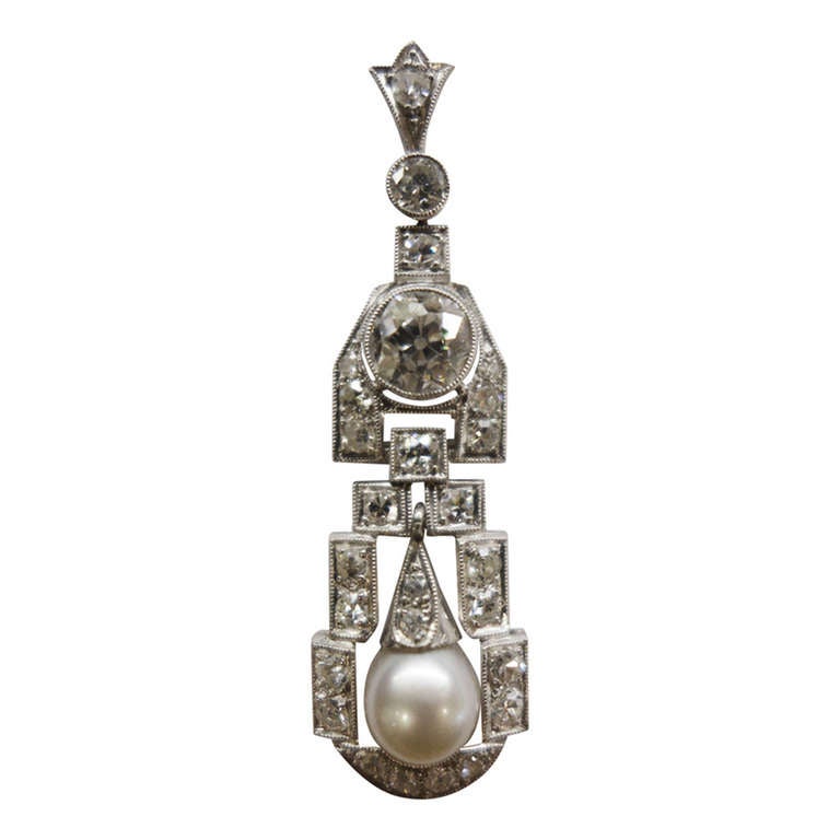 1920's platinum pendant set with old european cut diamonds and a pearl. For Sale