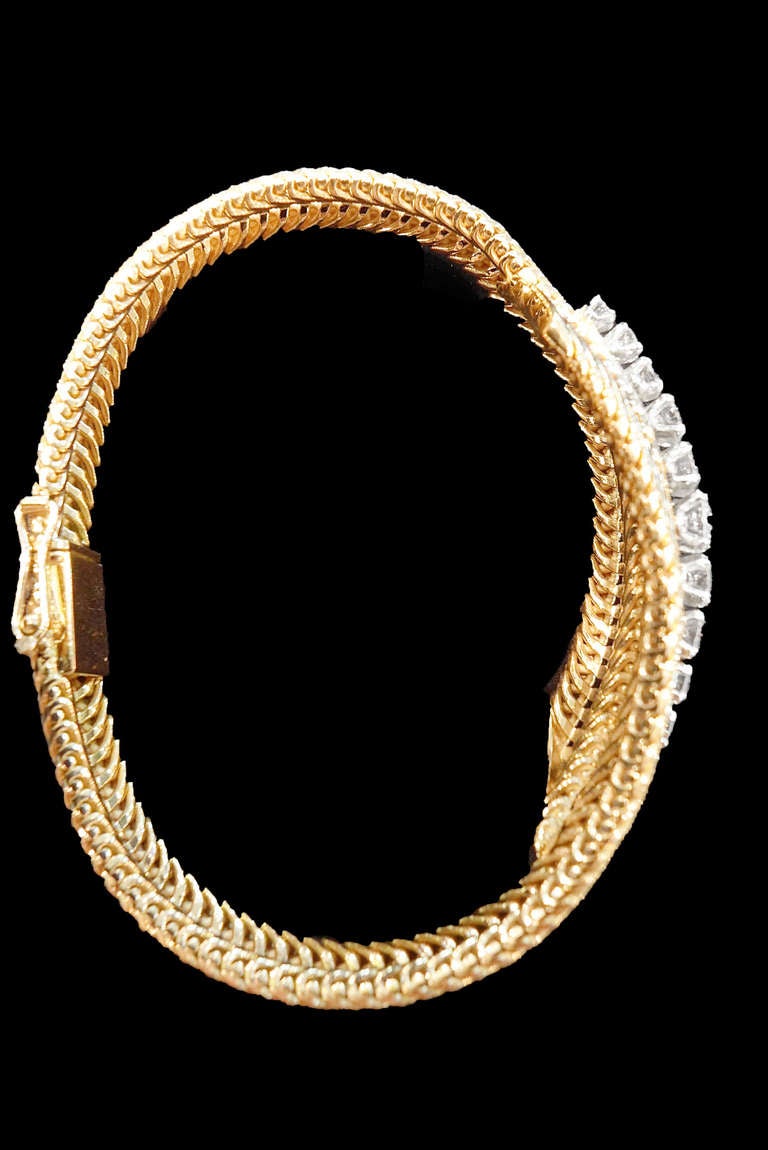 Pink gold and platinum 1950's bracelet set in the middle with a gradation of brilliant-cut diamonds. 

Diamond weight approximately 1.50 carats. 
Bracelet length: 180 mm. 
Weight: 33 grams.