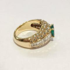 Yellow gold Cartier ring set with an emerald and diamonds.