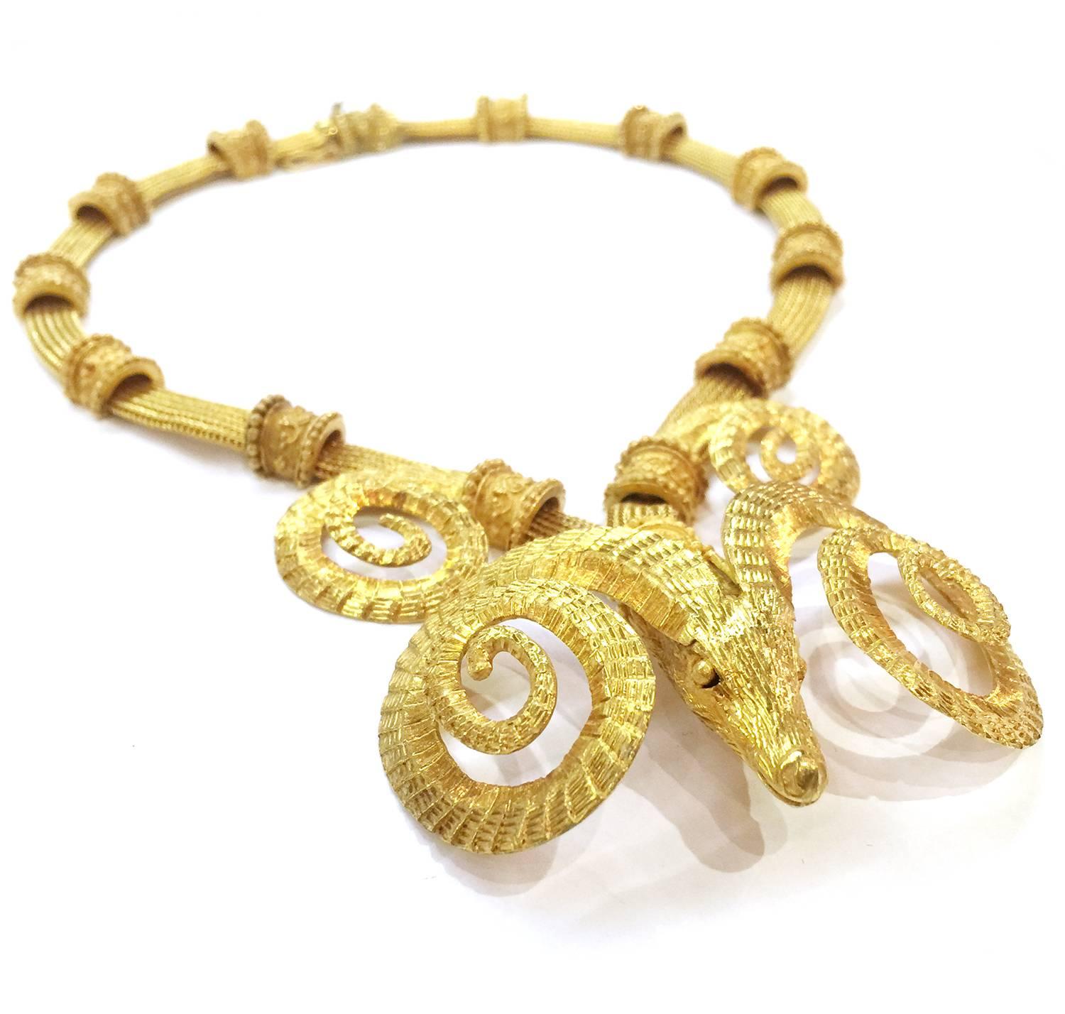 An exceptional yellow gold Zolotas necklace. The supple braided gold chain is enhanced by thirteen patterns. The last one is holding a ram's head, which is surmounted by huge ram horns so typical of the classical and neo-classical styles. 
Chain