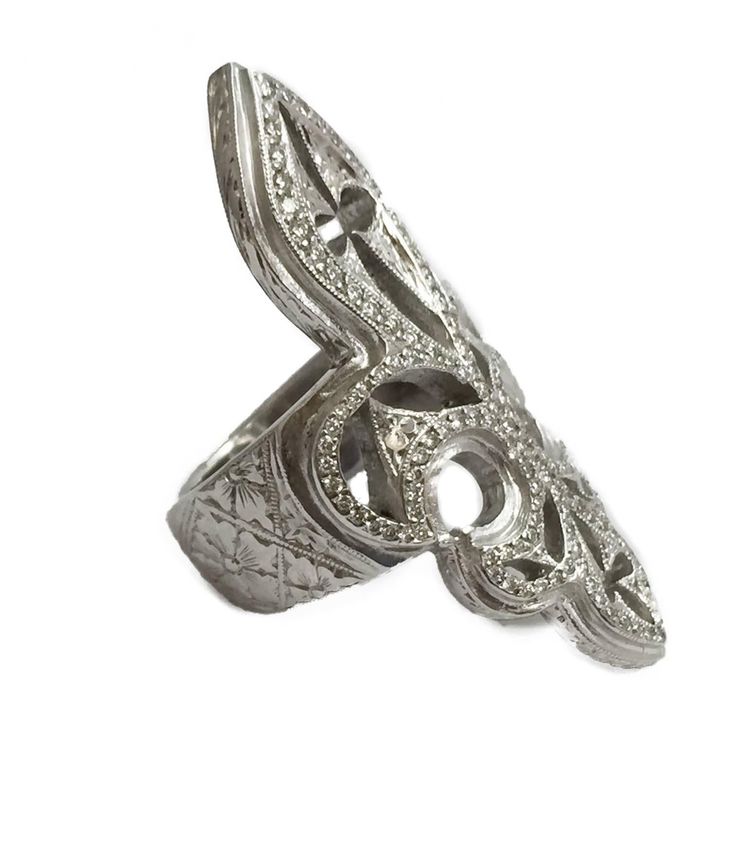 Trefoil engraving 18kt white gold extra large 'Cigar' band diamond ring signed by Loree Rodkin featuring a fleur-de-lis motif embellished with pavé set diamonds (1.80ct). Oversized shape. 
Length : 46 mm. 
Pattern's width : 21 mm. 
Weight : 27,9