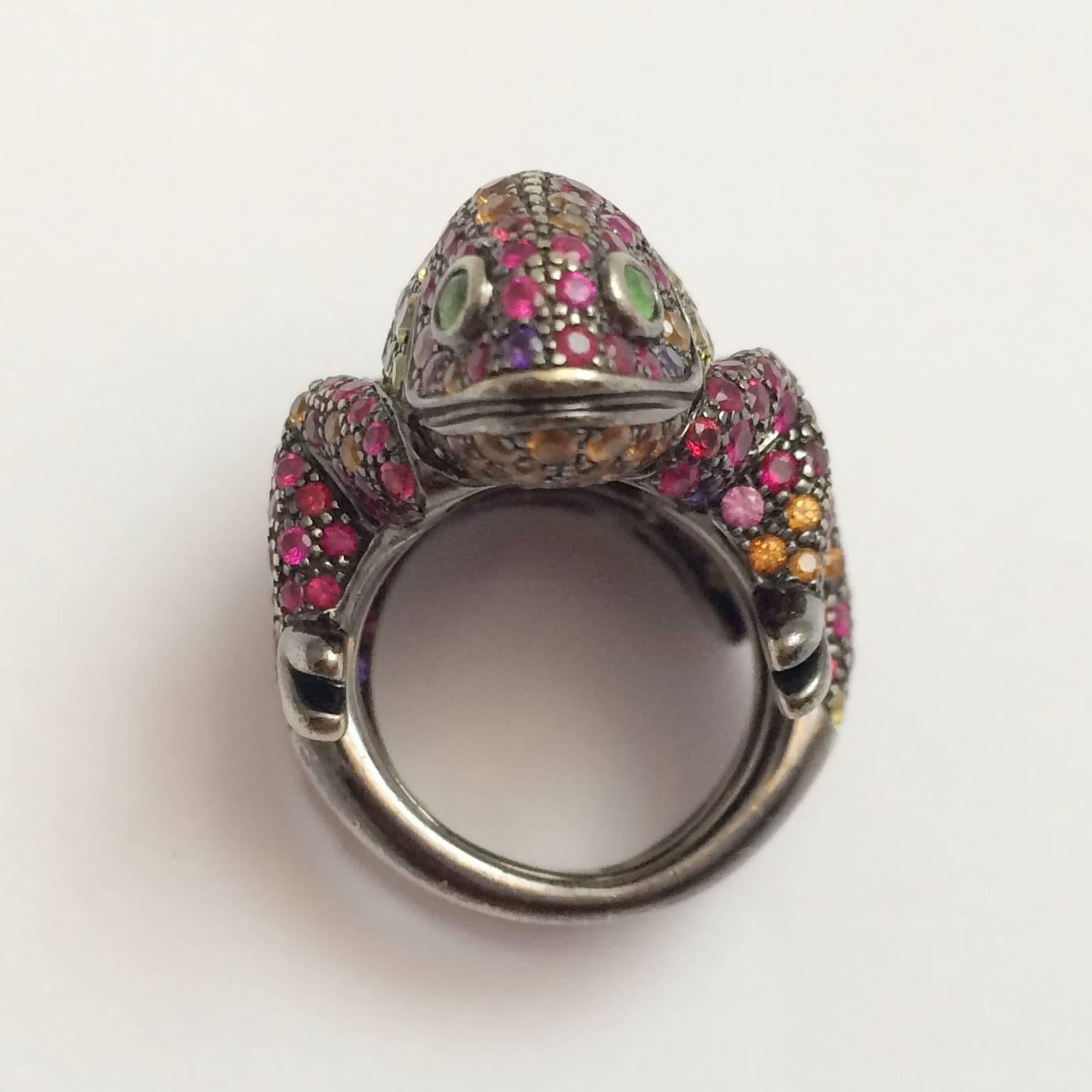 A 750/000 blackened gold Boucheron ring, made as a chameleon entirely set with multicolored sapphires, rubies and tsavorites. 
length : 23 mm. 
Width : 22 mm. 
Height on the finger : 11 mm. 
Finger size : 5 1/4 can be very slightly sized. 
Net