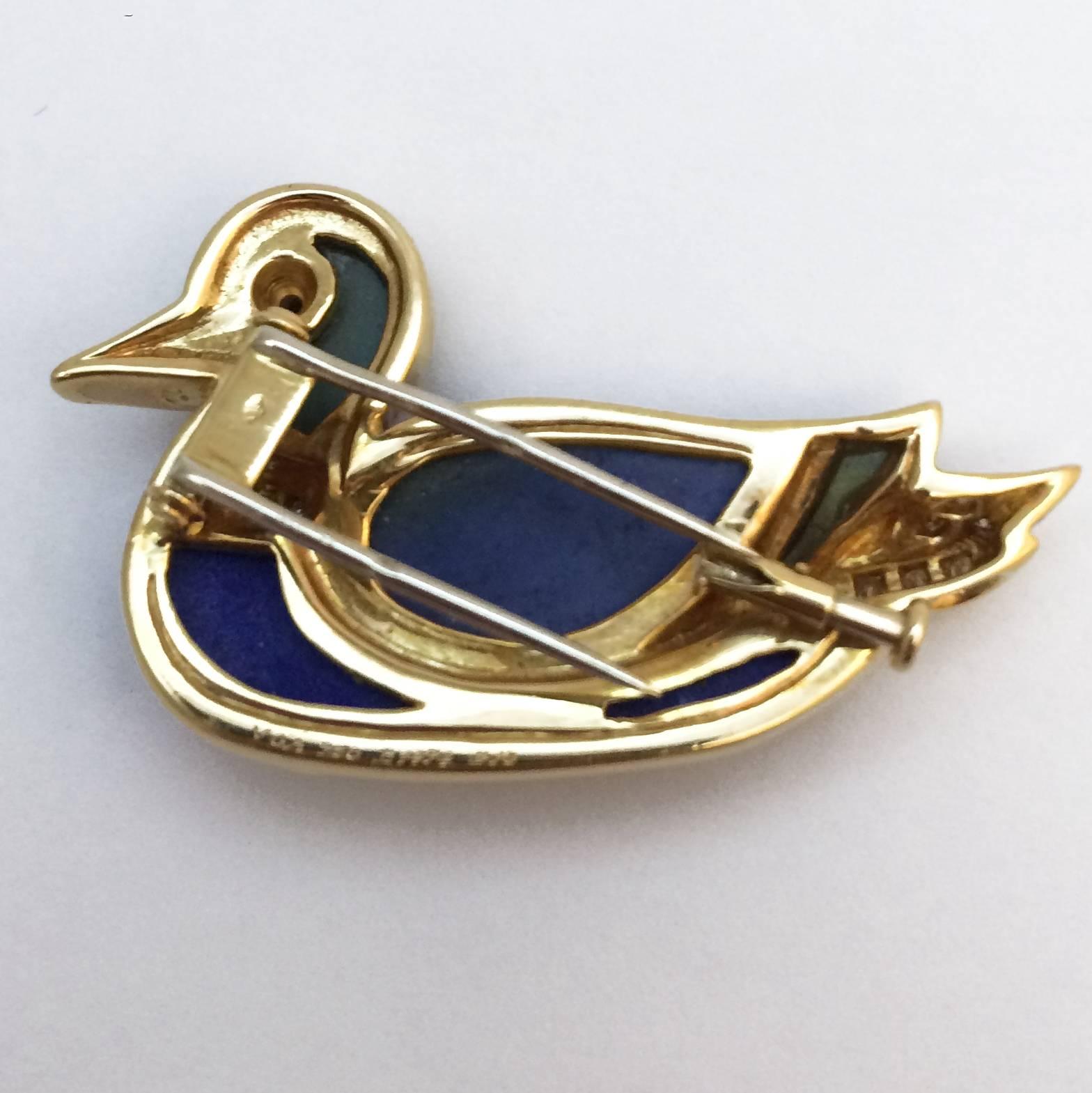 A yellow gold 750/000 Van Cleef and Arpels brooch figuring a profiled duck. The body is set with Lapis lazuli, the neck and the tail are set with brilliant cut diamonds, the head and the back of the wings are set with labradorite and the eye with an