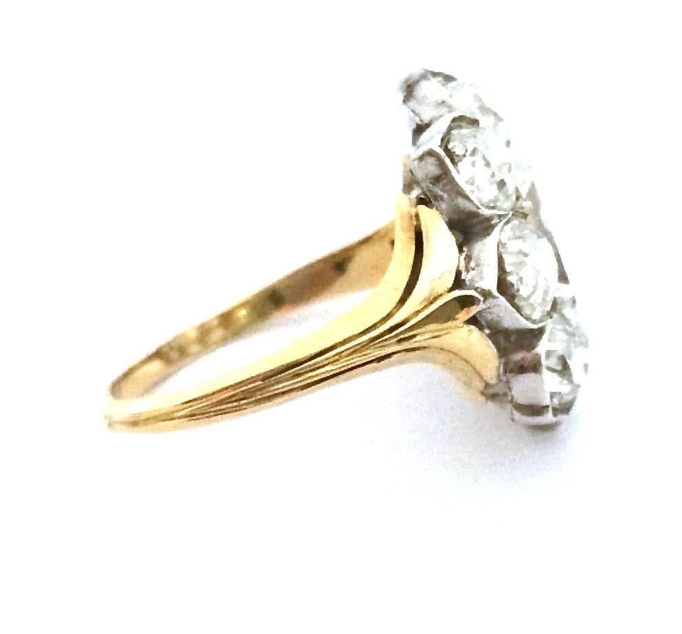 A 750/000 yellow gold ring set in the middle with an old cut rectangular diamond surrounded by eight old cut diamonds. They are set on 925/000 silver. 
Width : 16 mm. 
Length : 18 mm. 
Finger size : 6 1/2 can be sized. 
Net weight : 4 grams.