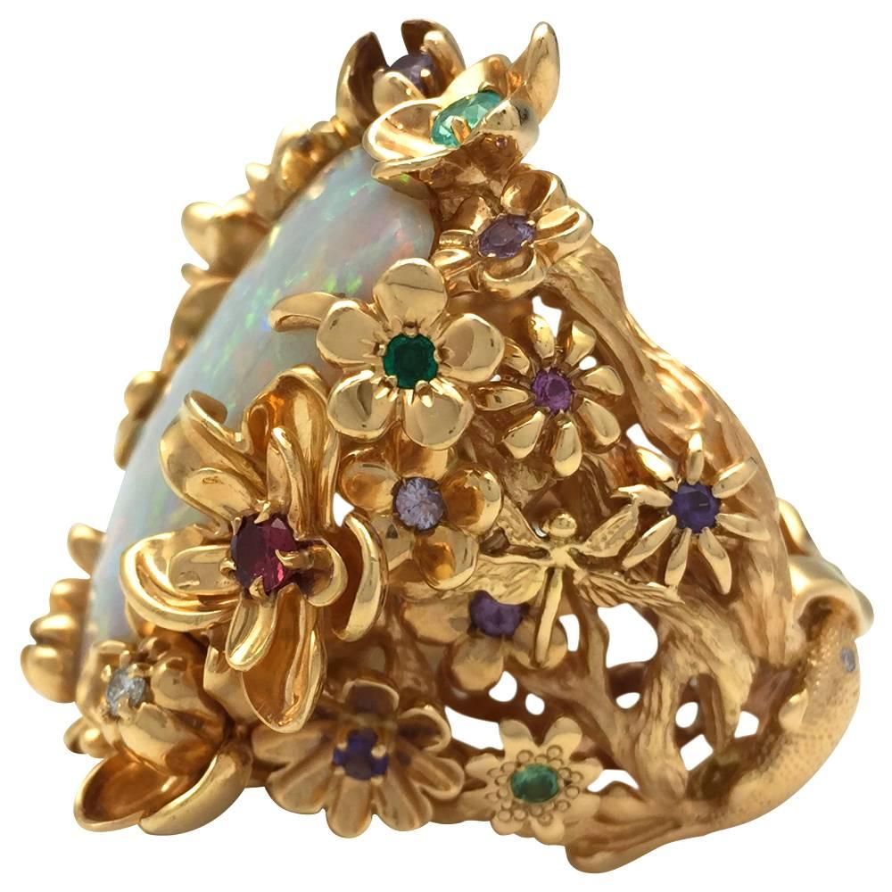 Exceptional yellow gold Dior cocktail ring centered with an important white opal, the ring is enhanced with floral, fish, dragonfly and a frog motifs, some of the flowers are centered with quartz, tourmalines, garnets, sapphires or diamonds.
Length