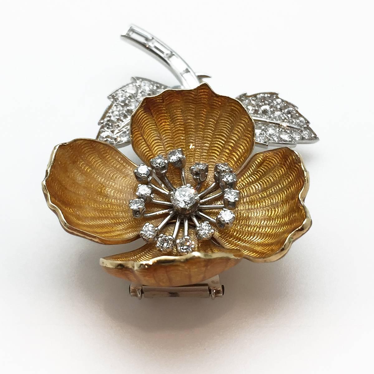 A beautiful Boucheron brooch "Eglantine" collection made in 750/000 gold and 950/000 platinum. This brooch is designed as a flower which stem, leaves and pistil are set with baguette cut or brilliant cut diamonds. The four 750/000 yellow