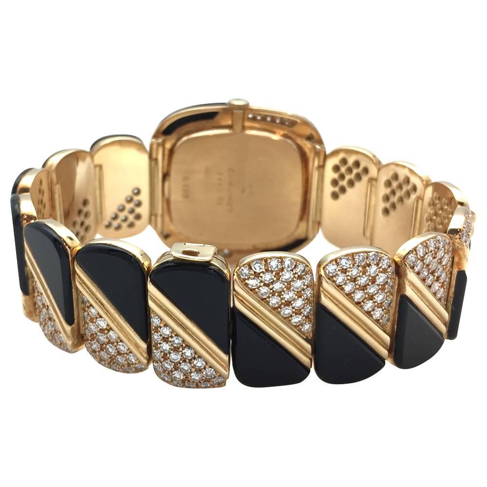 A 750/000 yellow gold vintage Chaumet DeLaneau watch. The dial and the bracelet are enhanced with a geometrical made of onyx, 490 brilliant cut diamonds and pop-shaped yellow gold motifs. 
Length: 33 mm
Width: 31 mm
Style Period 1970's
