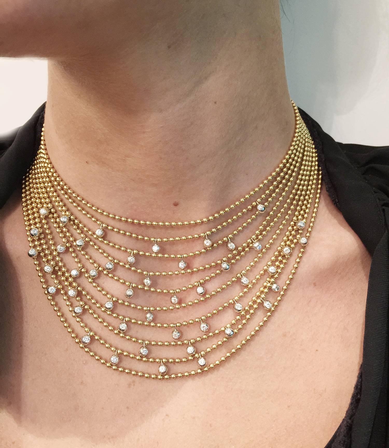 Yellow gold Cartier Drapery necklace set with 46 brilliants dispatched on 10 rows of bid chains.
Circa 1990.
Weight 117 grams
Inside diameter : 340 mm (short size)