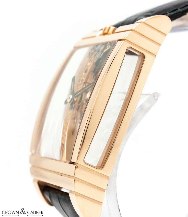 Brand: Corum
Model: Golden Bridge
Model Number: 113.750.55 
Case: 18k rose gold curved tonneau case with sapphire crystal panels on both sides to view with visible Golden Bridge movement.
Hands: Black oxydized gold skeleton hands
Case