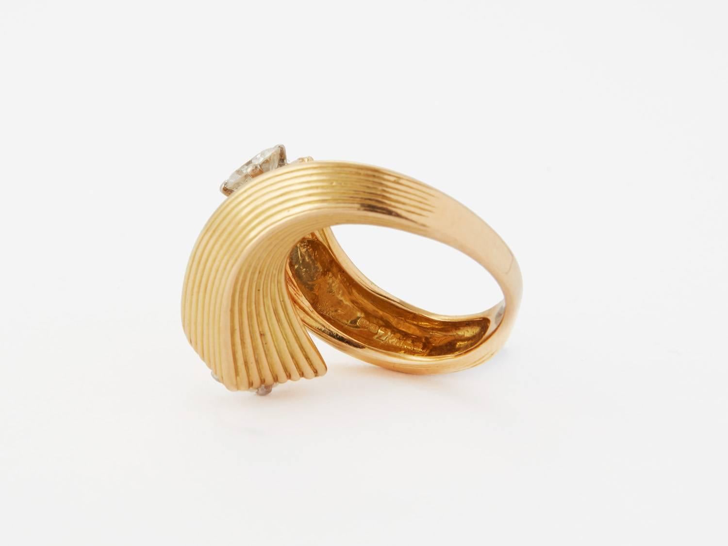 Kutchinsky Twist Ring, 1969, signed Kutchinsky and stamped with London Hallmarks with date letter 'o'

18k gold with 2 diamonds; ring size: P

The Kutchinsky family business was established in the 1980's in England, setting up a jewellery