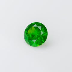 0.55 ct, Faceted Russian demantoid garnet with horsetail inclusion