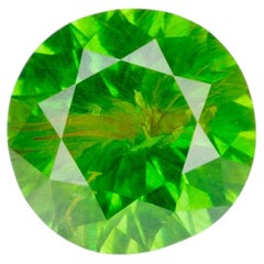 0.47 ct, Faceted Russian demantoid garnet with byssolite inclusion