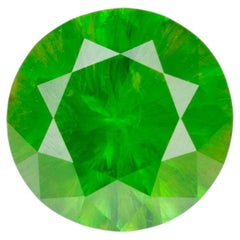 0.48 ct, Faceted Russian demantoid garnet with horsetail inclusion