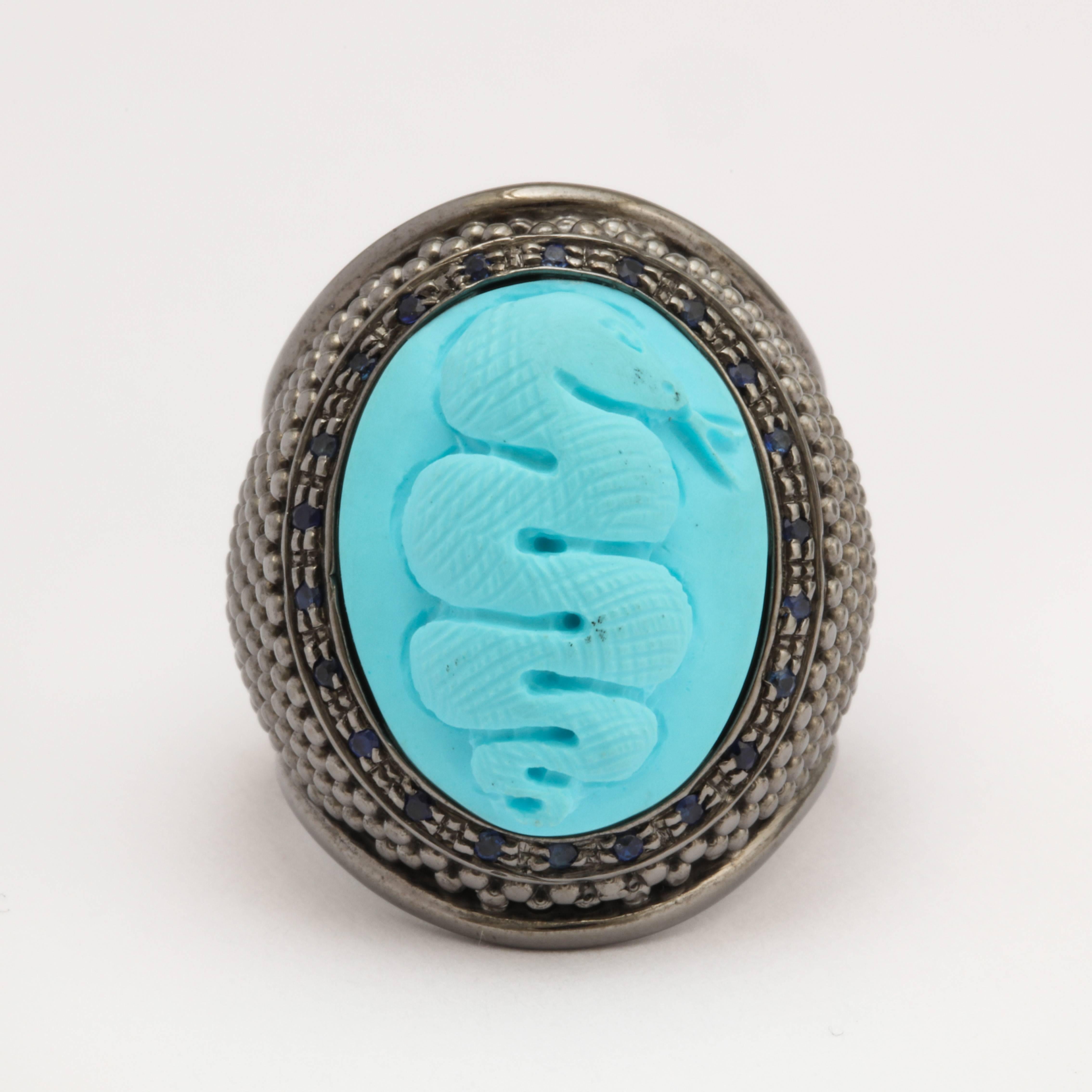 20mm turquoise shell cameo, set in sterling silver black rhodium plated with blue sapphires.
