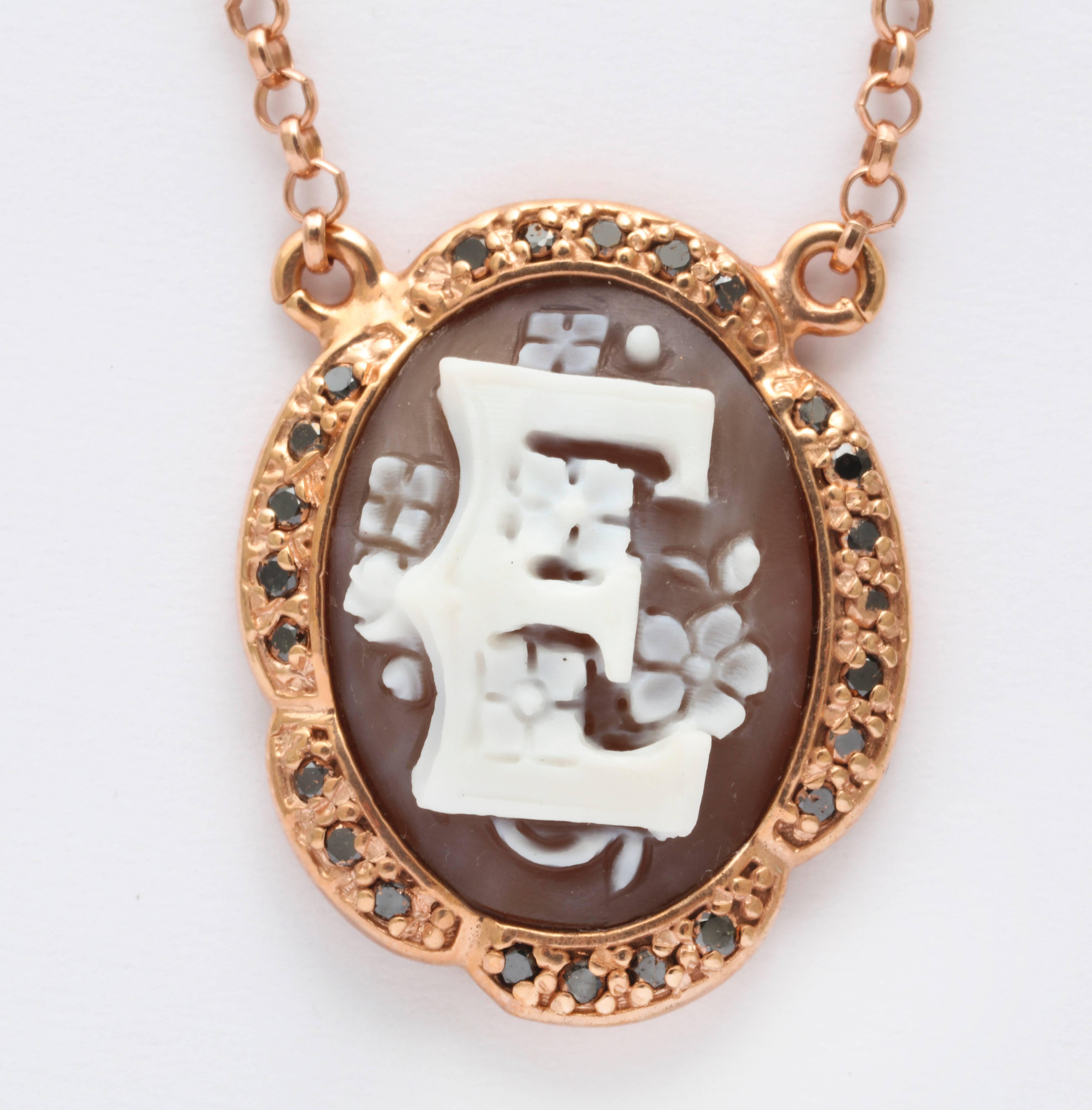 20mm sardonyx shell cameo hand-carved set in sterling silver rose rhodium plated with black diamonds.
Chain length: 18"                          