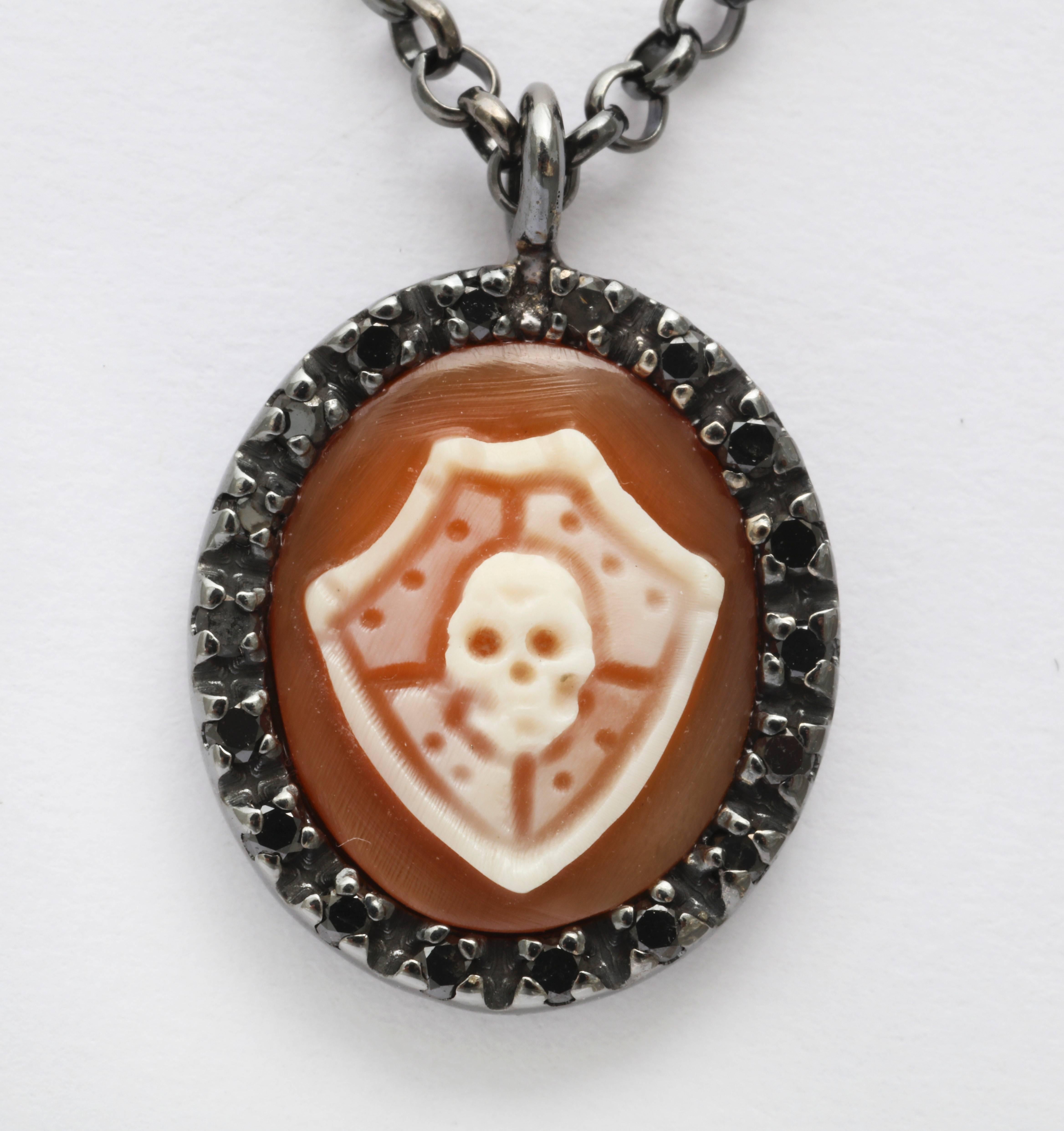12mm cornelian shell cameo, hand-carved set in sterling silver black rhodium plated with black diamonds.
Chain lenght: 24".