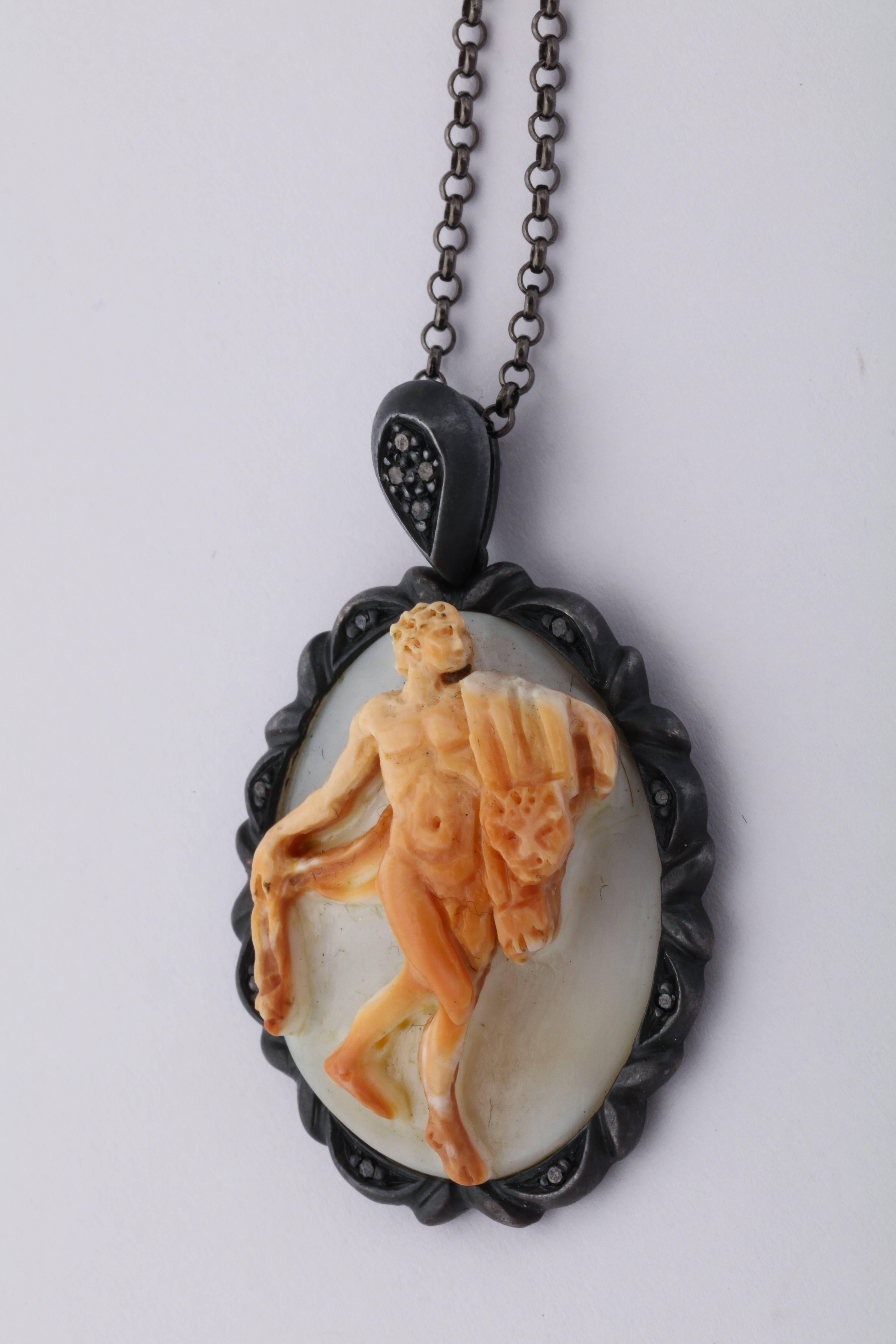 Triple carved cornelian cameo, set in oxidized sterling silver with black diamonds.