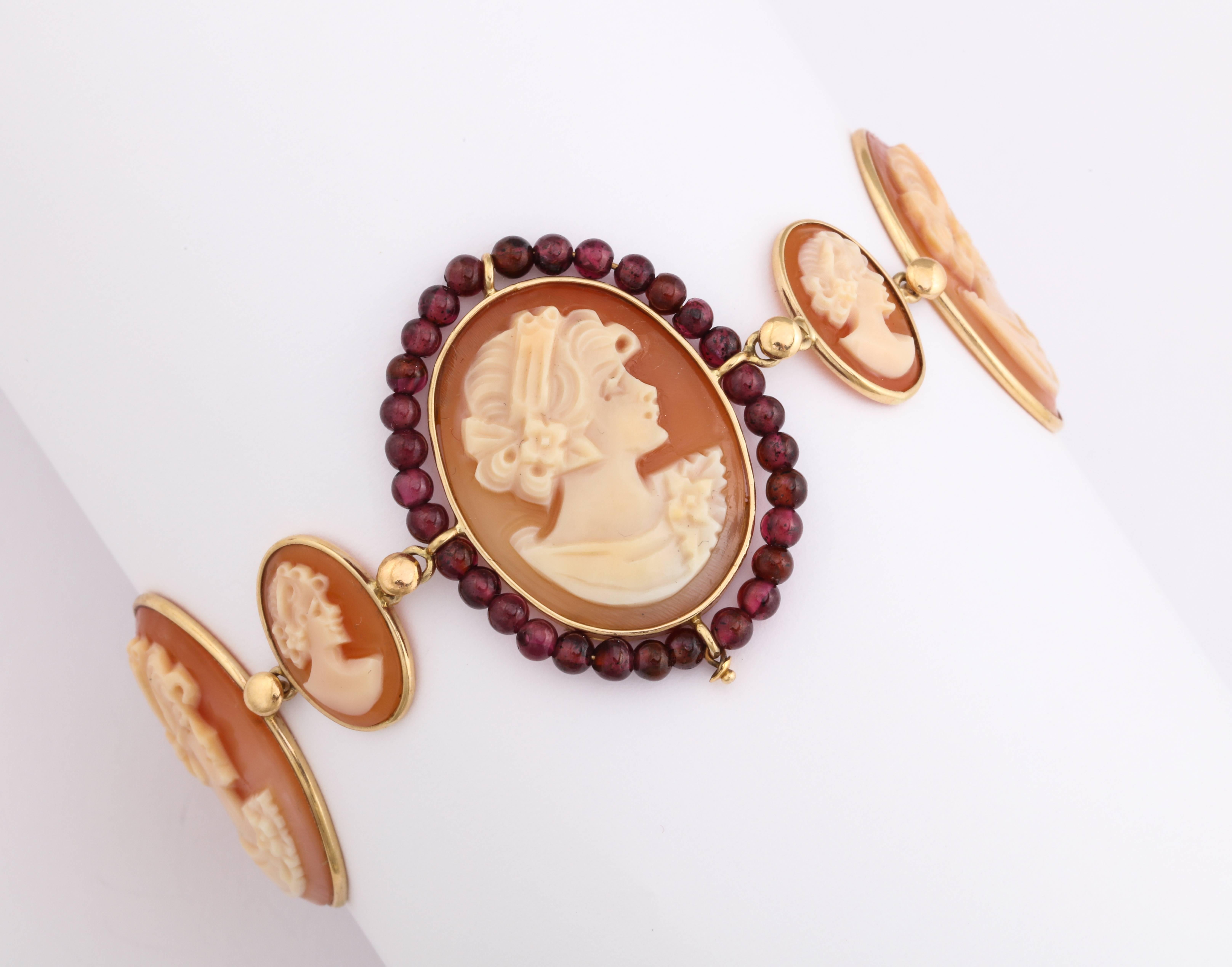 Hand carved cornelian shell cameos set in 14kt gold bracelet with garnet beads.