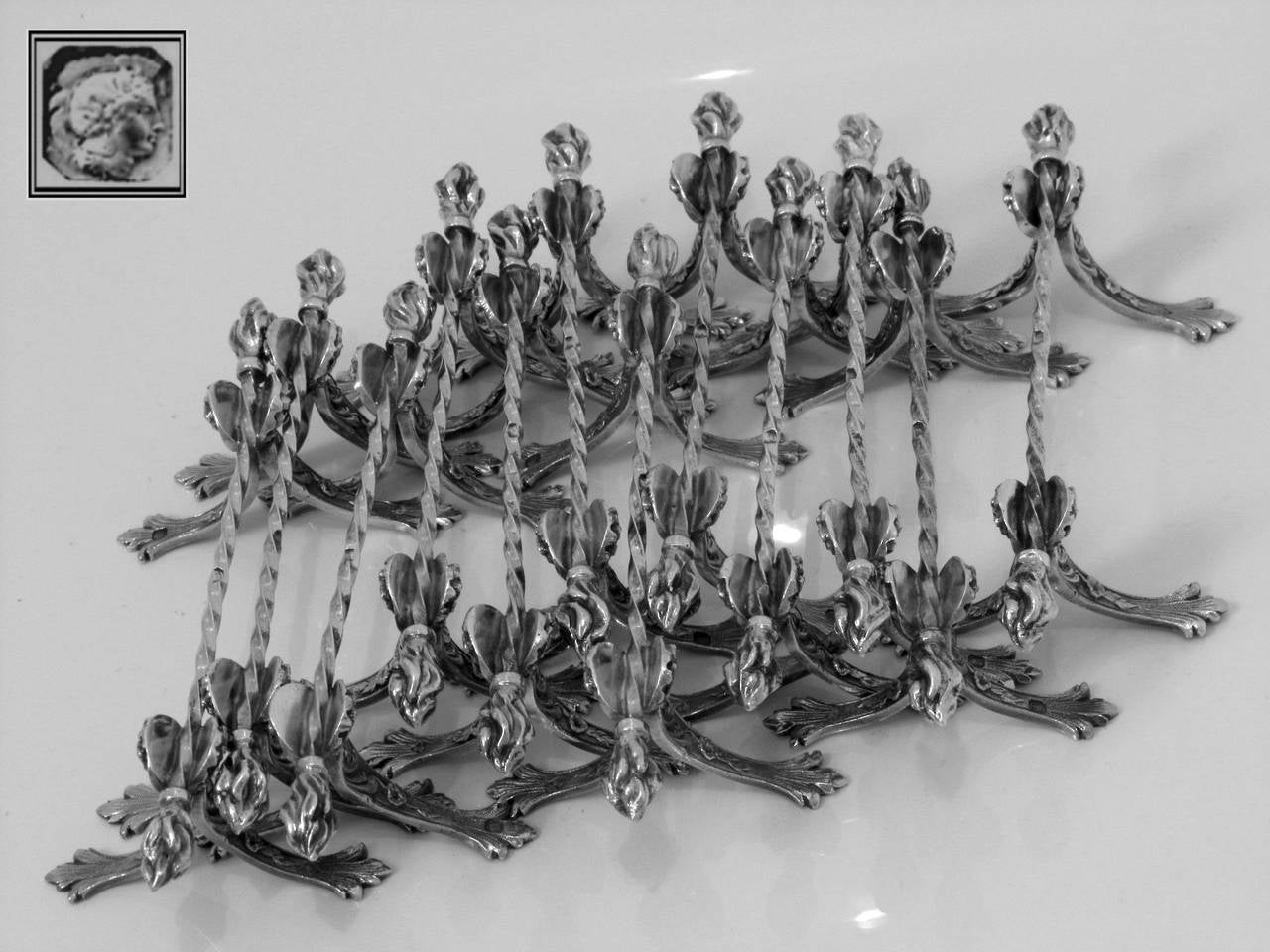 Queille Amazing French All Sterling Silver Knife Rests Set 12 pc Torches model

Extremely rare model of knife rests set. It is even rarer to see full service of 12 pieces of french sterling silver. These objects are usually made of silverplate.