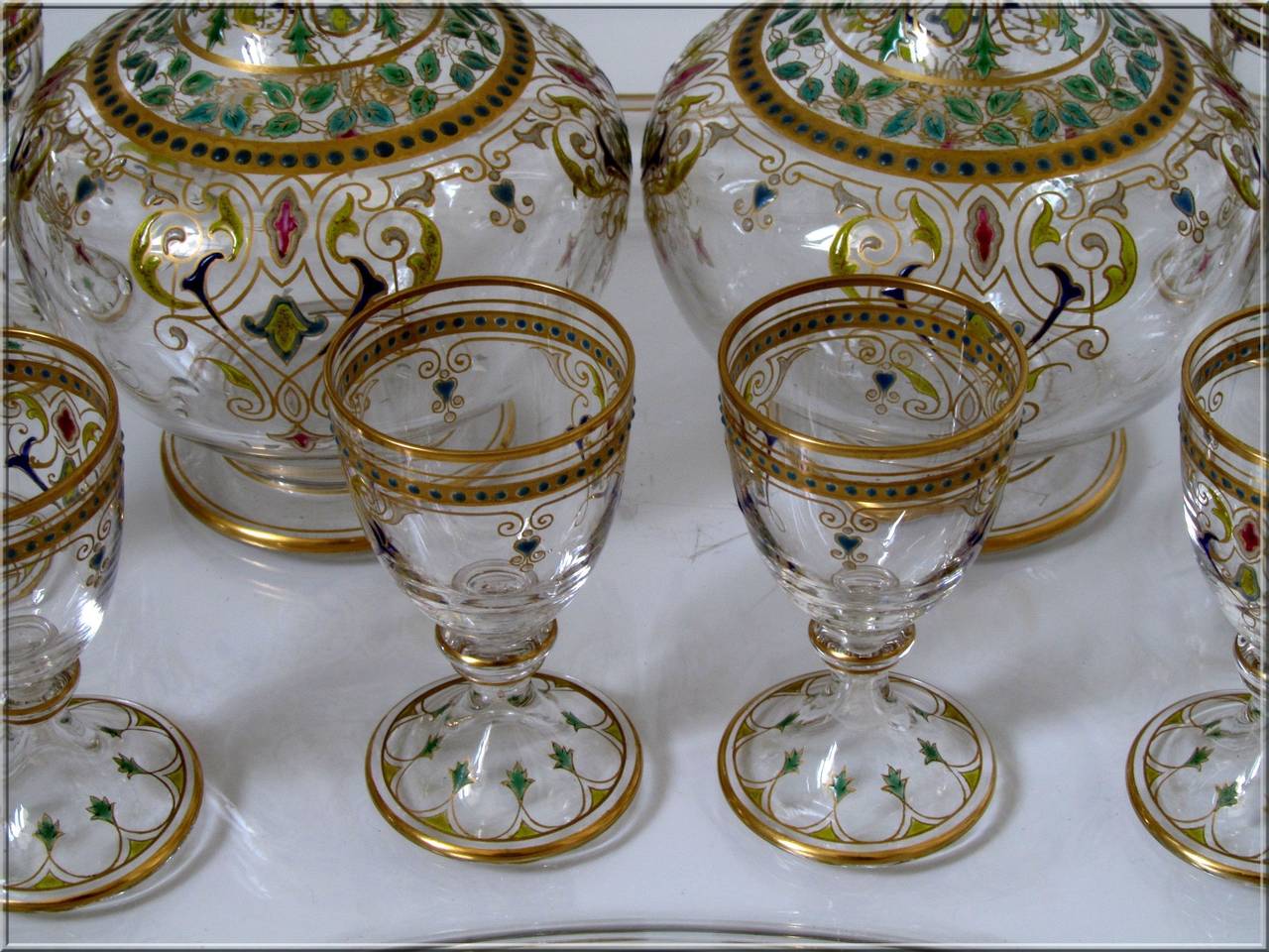 1870s Rare and Antique French Baccarat Enameled Crystal Liquor Service Decanters Pair, Cordials, Tray

Exceptional and antique French Baccarat crystal liquor service Moorish-inspired décor., Napoleon III period. Comprising two decanters, eight