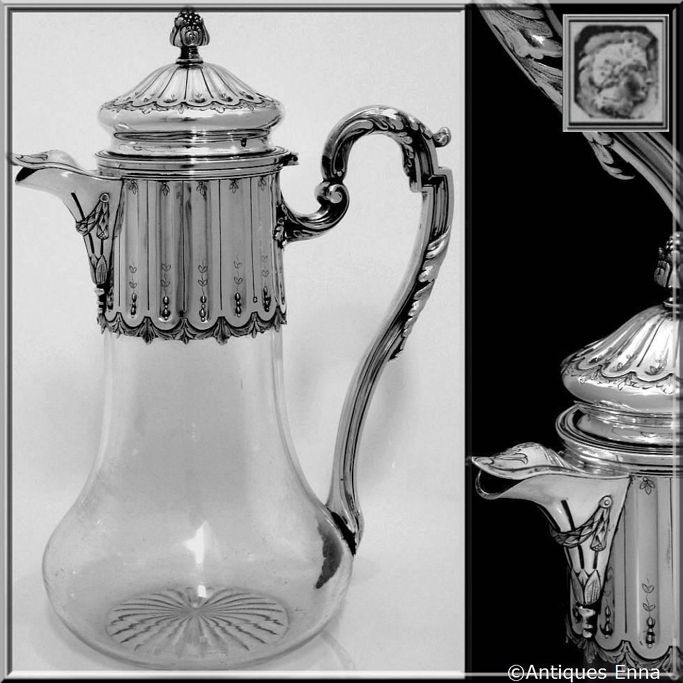 Antique French Sterling Silver & Crystal Serving Decanter, Pitcher Neoclassical

Large antique French sterling silver and cut crystal decanter or pitcher. Mounted with sterling silver collar and hinged lid, patterned Louis XVI with laurel wreath.