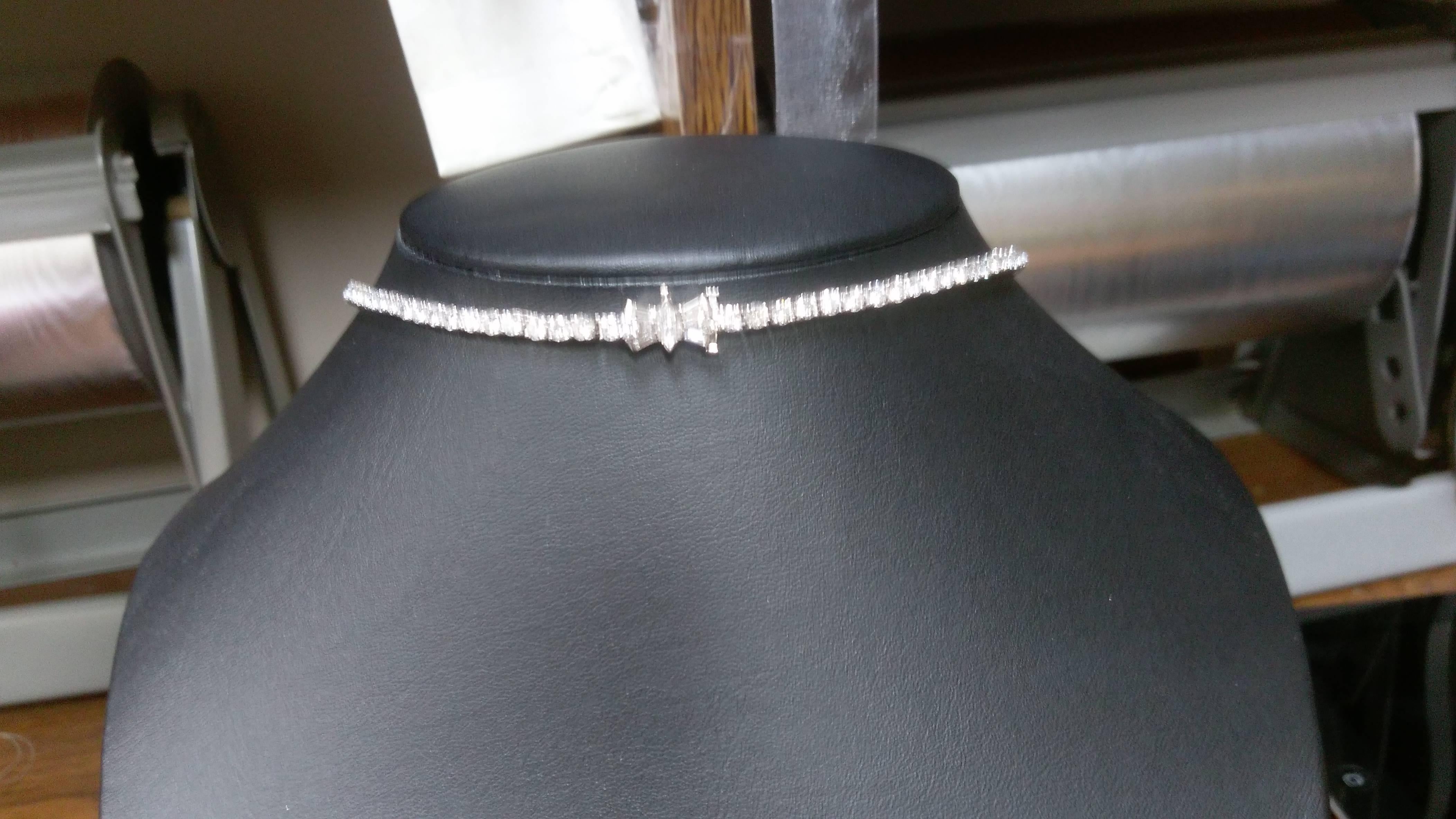 Platinum Art Deco choker necklace set with 99 round graduated diamonds weighing approximately 17.40 ct. tw.  Necklace closes via box clasp with fold over safety  and is set with 6 baguette diamonds and 1 marquise diamond weighing approximately .30