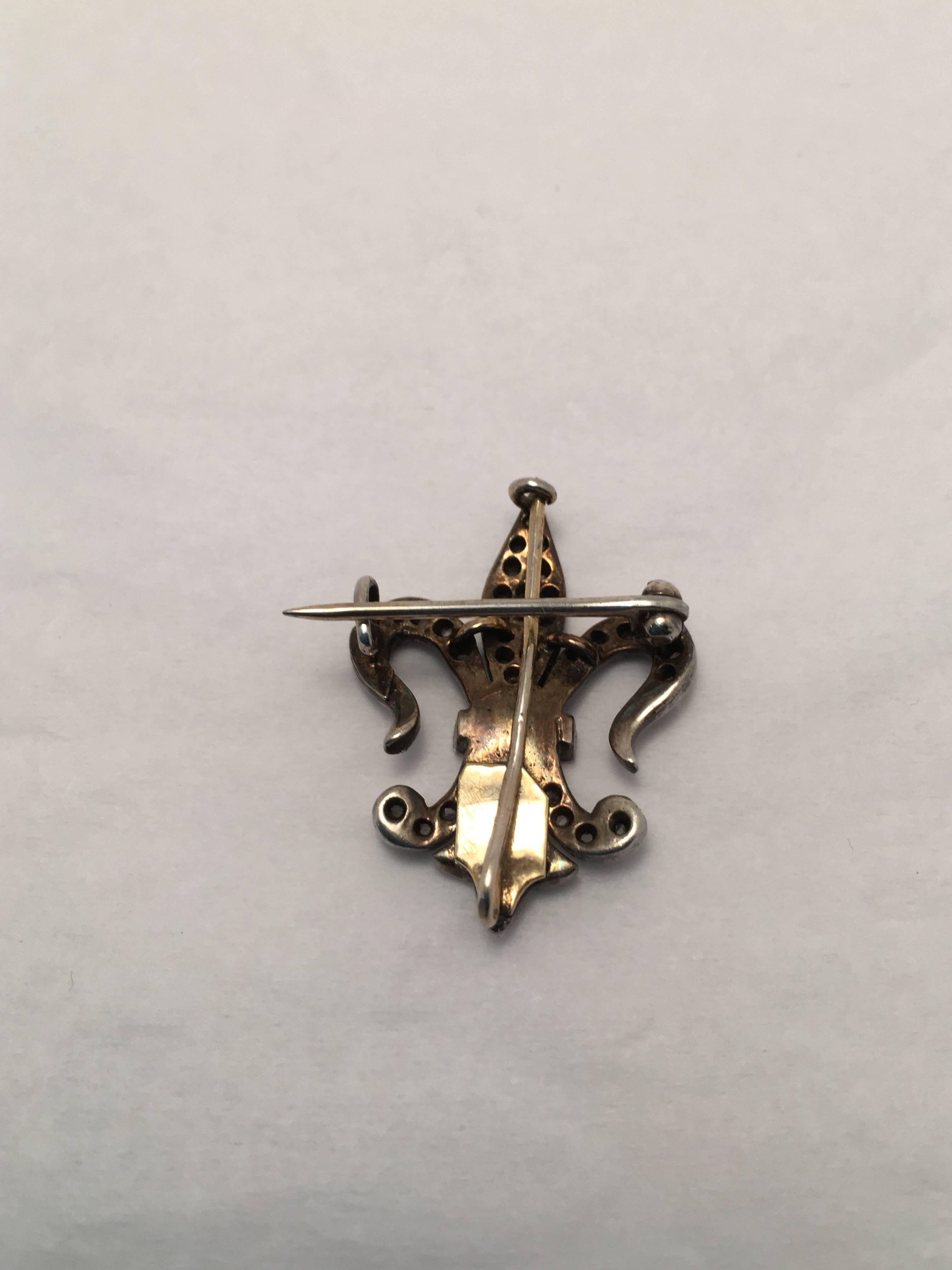 14 kt. yellow gold and silver Fleur de Lis watch hanger set with 67 rose cut diamonds weighing approximately 1.00 ct. total weight. This piece has wonderful milgrain details and pin assembly closes via 