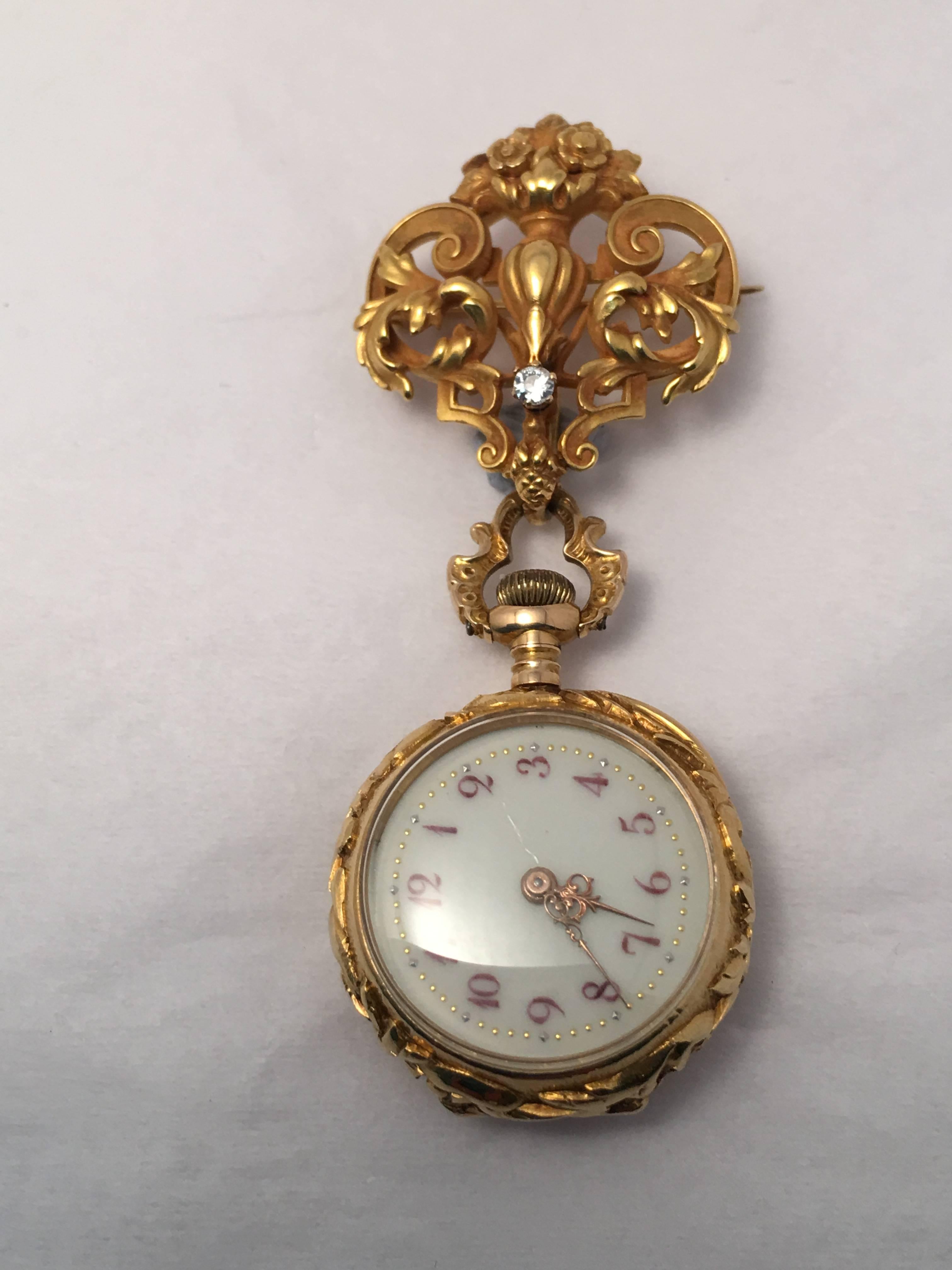 This 18 kt. yellow gold Art Nouveau Demi Hunter lapel watch hangs from an original Art Nouveau watch hanger which is set with one old European cut diamond weighing approximately .05 ct.  The watch is center set with one old European cut diamond