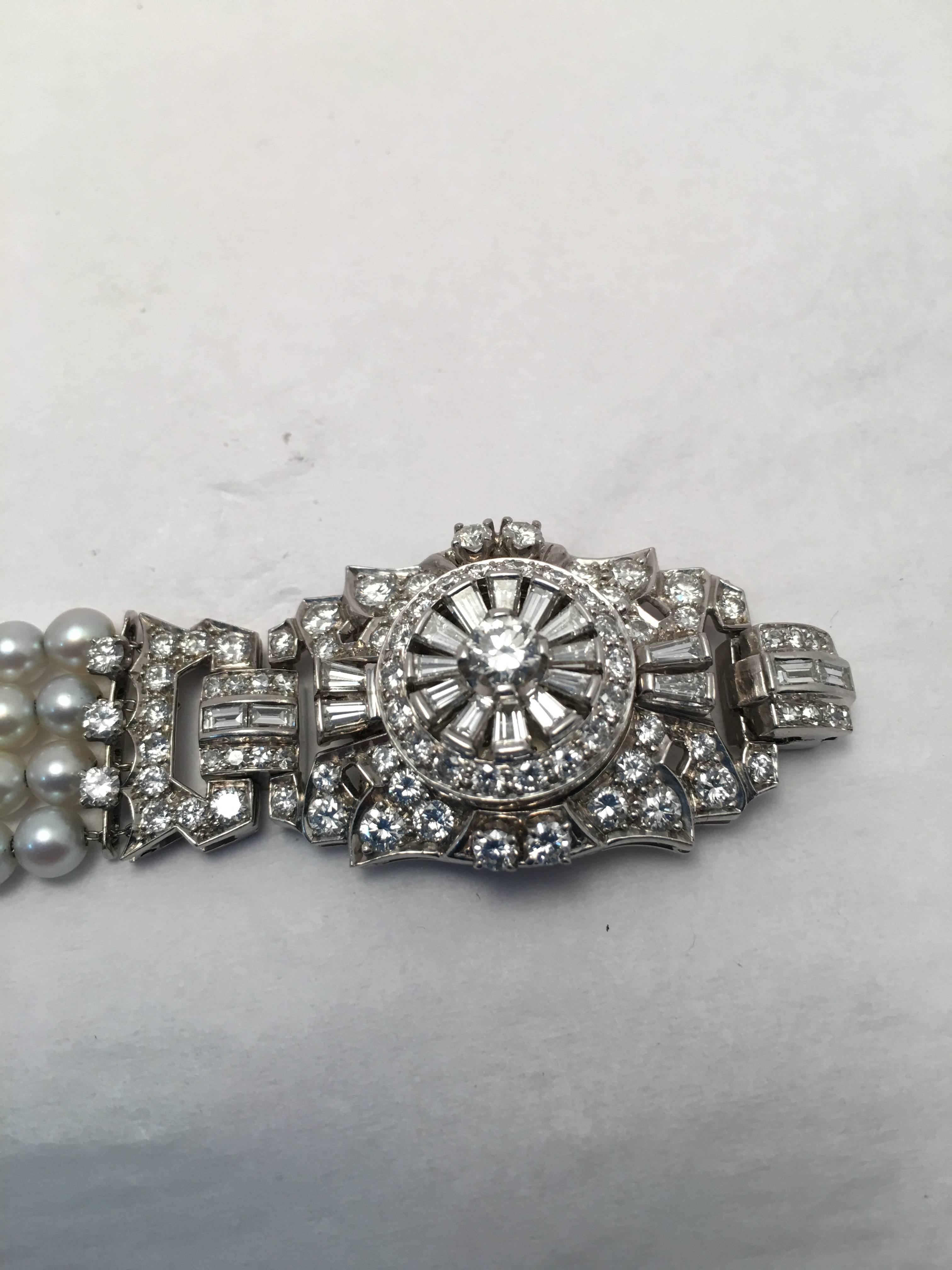 Platinum four strand watch/bracelet is set with 144 round and baguette diamonds totaling approximately 2.65 ct. and 96 pearls measuring 4-4.5 mm. each.   Movement is not in working order but is a very unusual bracelet to suit the distinctive