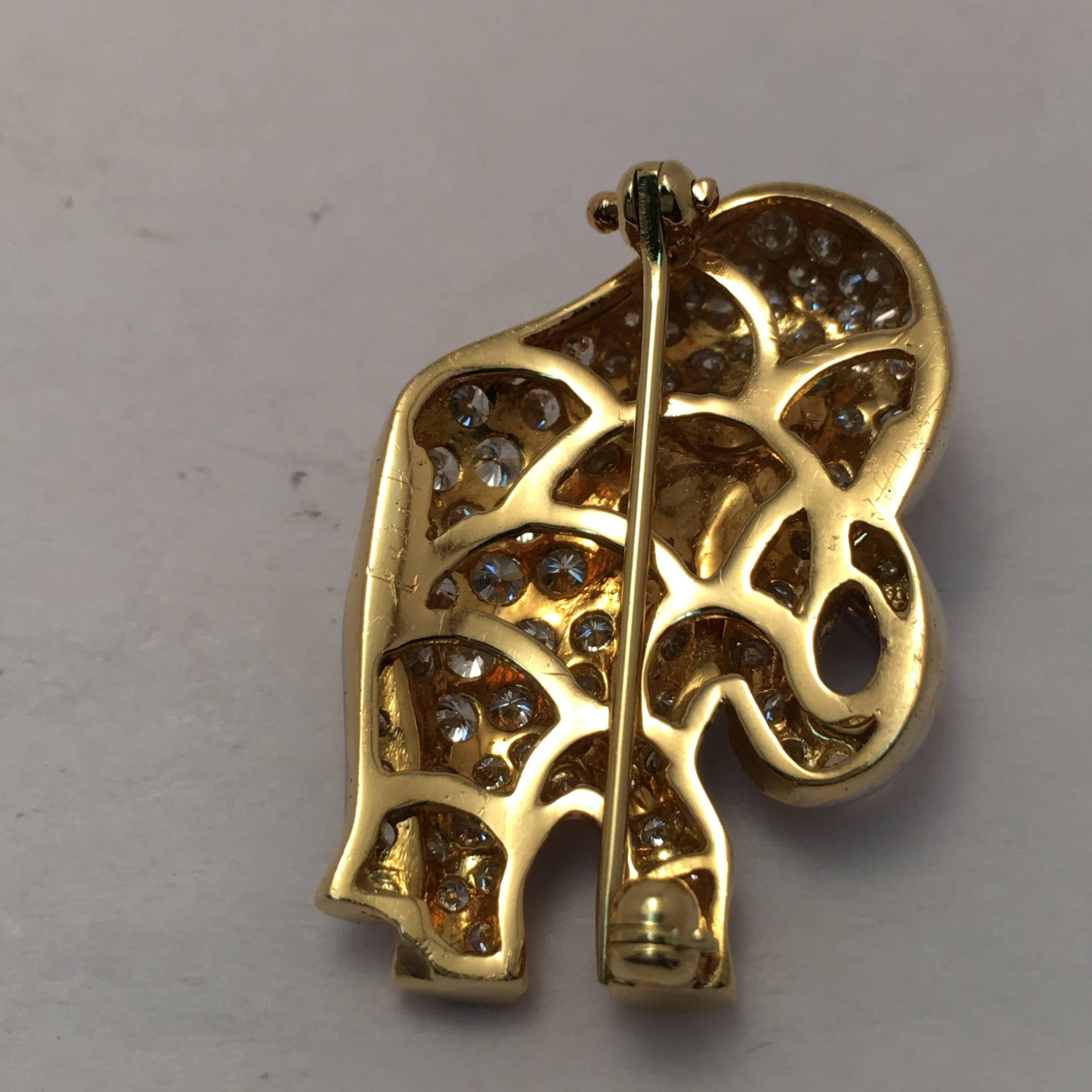 This 18 Kt. yellow gold elephant brooch is meticulously set with 106 full cut round diamonds weighing approximately 3.15 ct. total weight and one round cut emerald for the eye.  Whether making a political statement or animal lover, this makes a