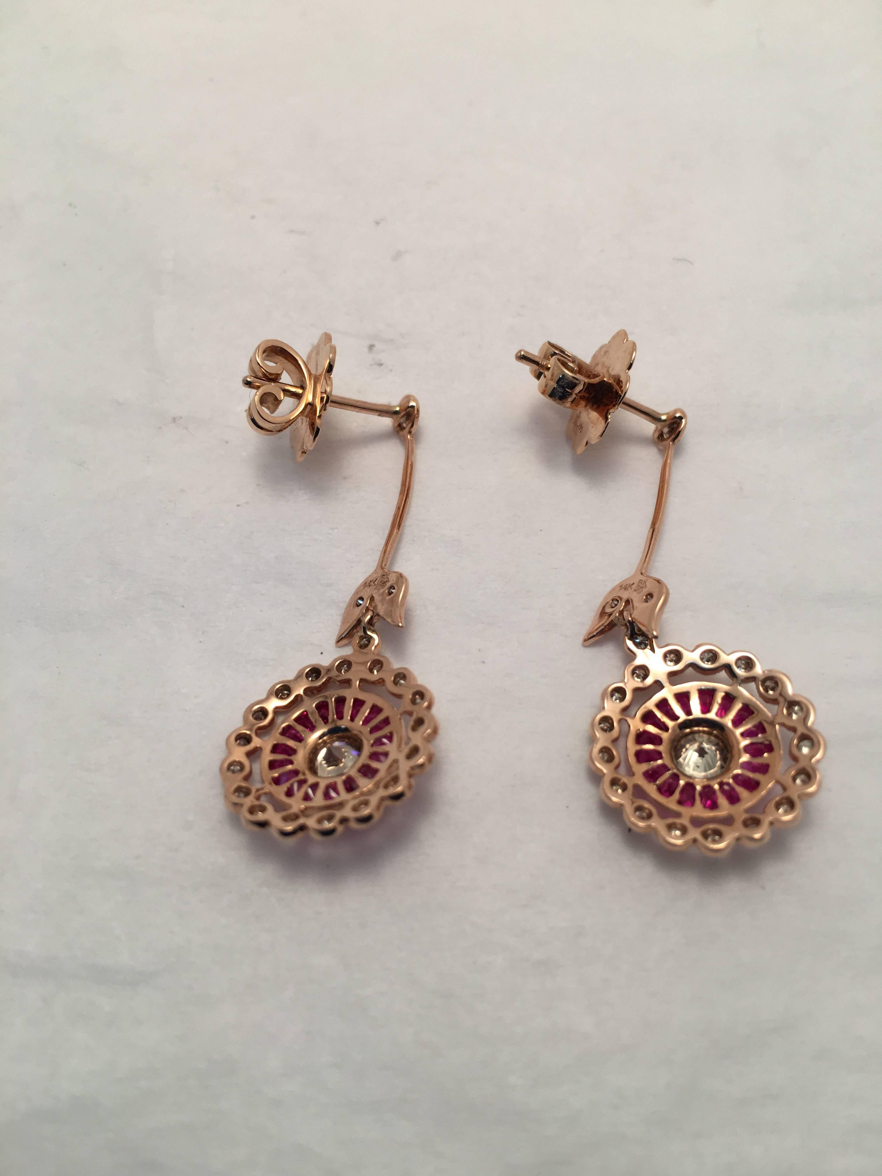 These gorgeous drop earrings are set with calibre cut rubies weighing 1.64 ct. total weight and .81 ct. total weight in diamonds.