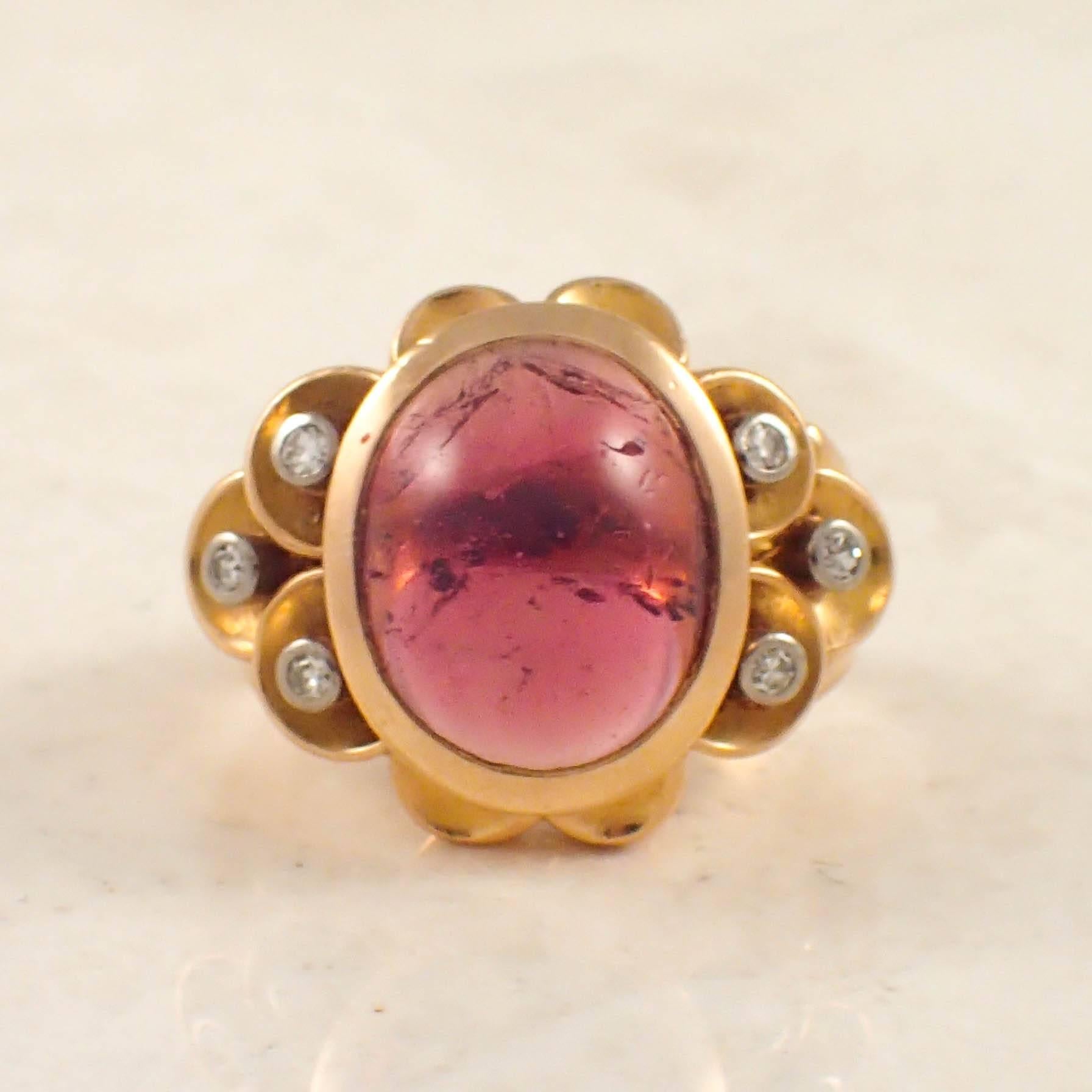 Retro 18k rose gold tourmaline and diamond ring. The retro ring is set with one oval shape cabochon cut pink tourmaline measuring 13 X 11 mm and six small single cut diamonds. Circa 1940s.