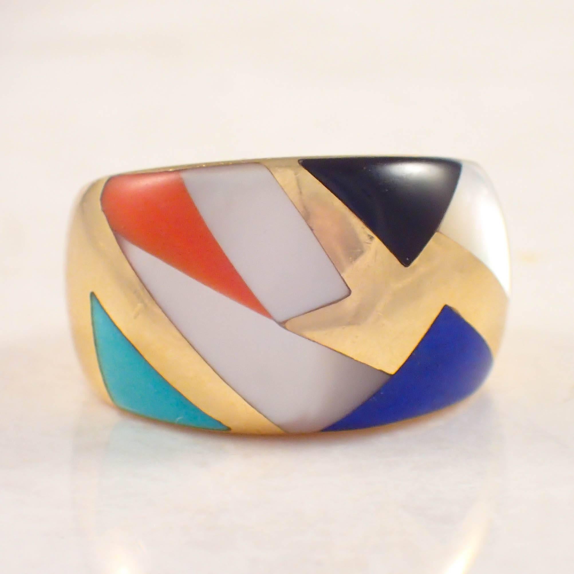 14K Yellow gold Asch Grossbardt inlaid band. The wide top is inlaid with lapiz, mother of pearl, onyx and turquoise. The band measures 13.2 mm at the center and weighs 6.8 DWTs/ 10.5 grams. Stamped 