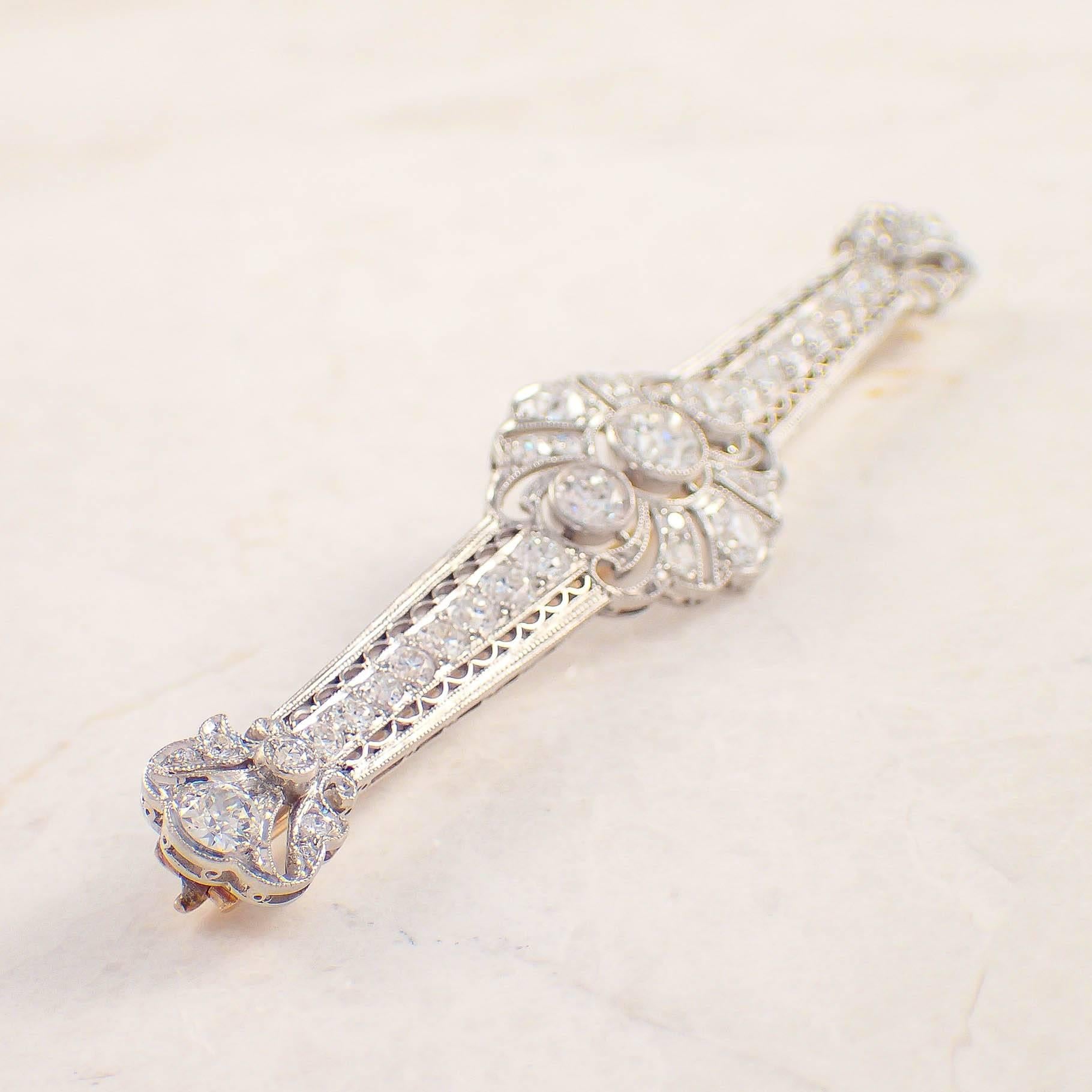 Tiffany & Co. Art Deco platinum diamond bar pin. The open work brooch is set with 41 old European cut diamonds weighing approximately 3.00 carats total. The brooch measures 3 inches and weighs 6.1 DWTs/ 9.4 grams. Stamped 