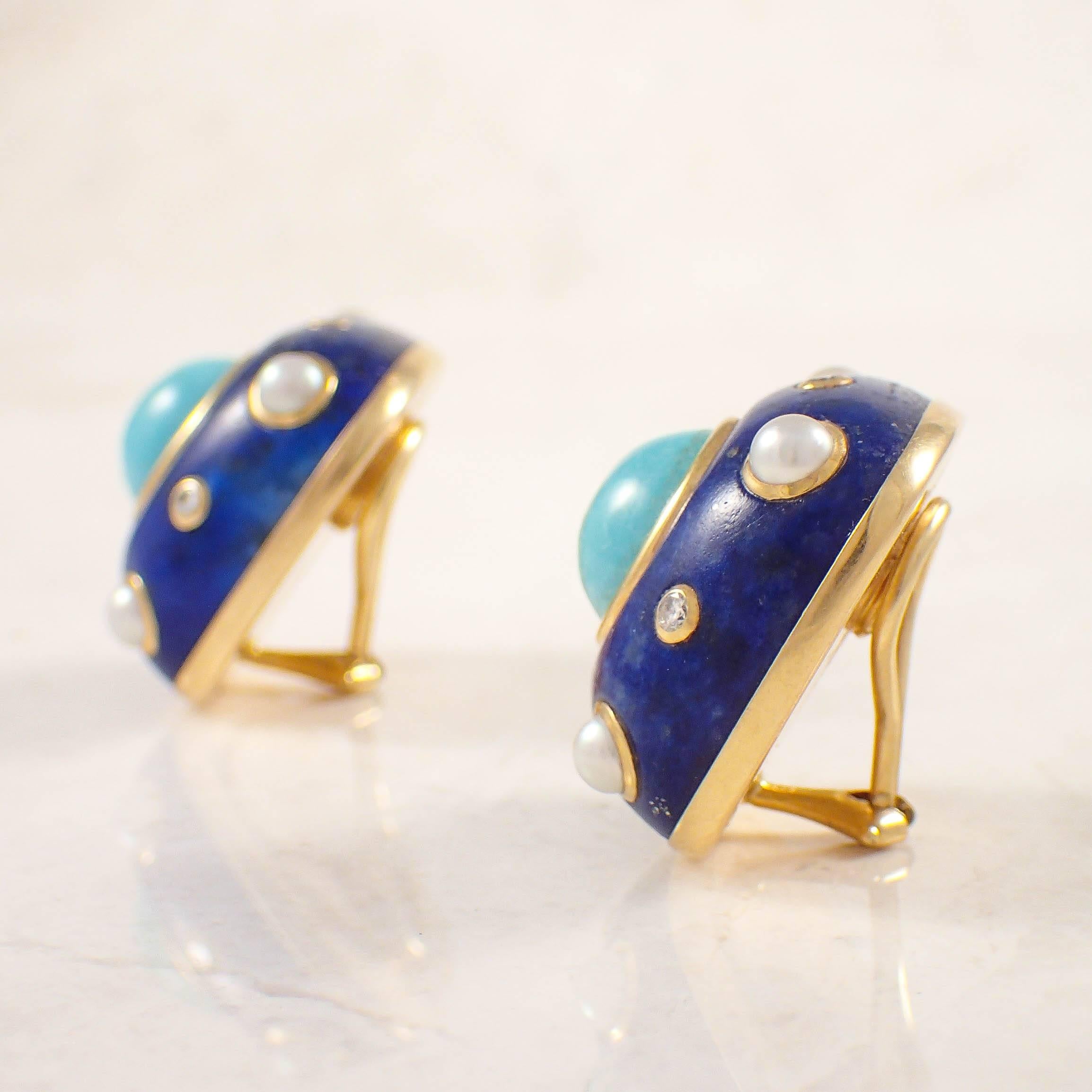 18K Yellow gold Trianon lapiz, turquoise, pearl and diamond earrings. The cushion cut lapiz base measures 24.7 X 24.7 mm, and is set in the center with one round turquoise measuring 11 mm. The earrings are decorated with 8 half seed pearls measuring