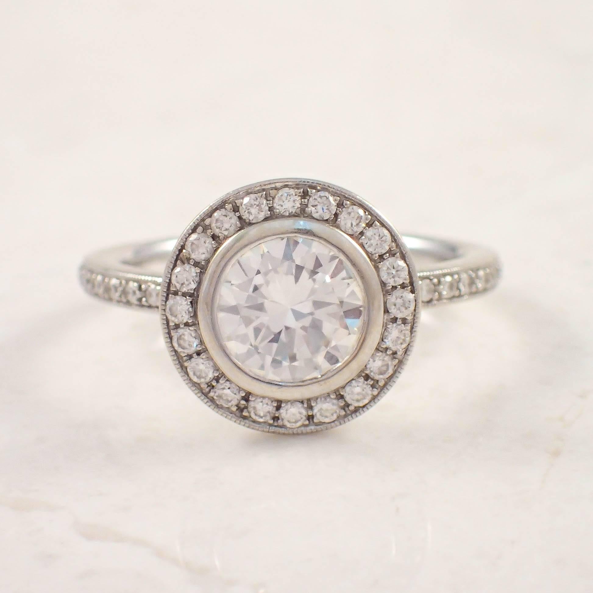 14K White gold diamond engagement ring. The cluster style ring is centered with a GIA certified, 1.00 carat round diamond accented by 38 small round diamonds weighing approximately .30 carat total. The ring weighs 2.3 DWTs/ 3.5 grams. Size 6.

GIA