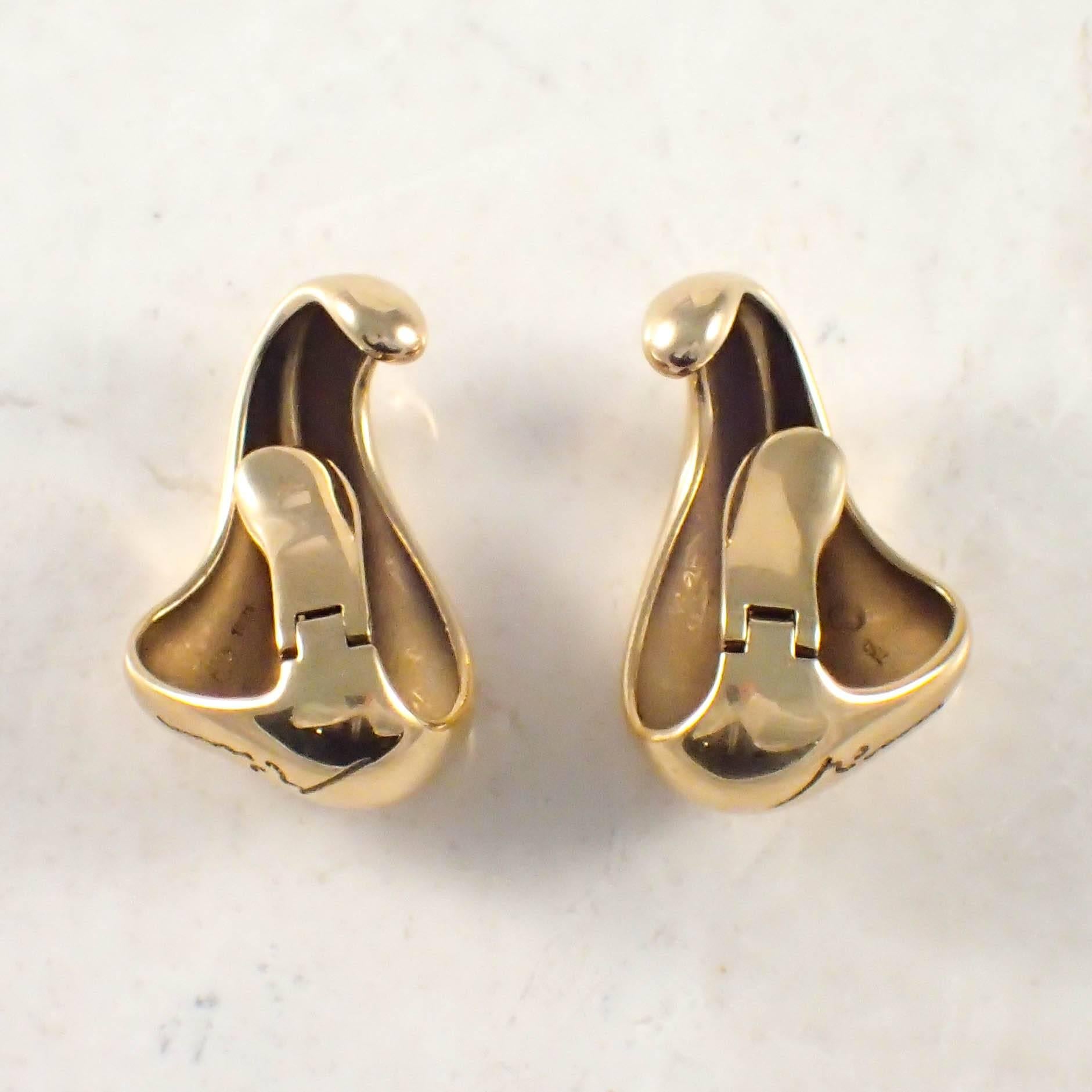 18K Yellow gold Georg Jensen earrings. The ear cuff clip-on earrings measure 1 1/4 X 3/4 inch and weigh 15.9 DWTs. Stamp Georg Jensen 1221 750. Circa 1960s.