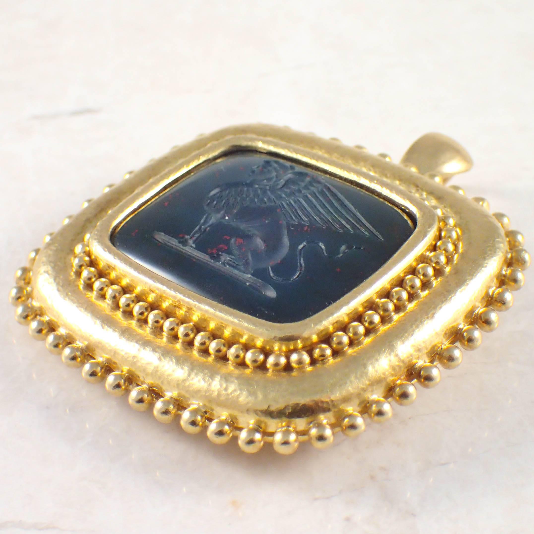 18K Yellow gold Elizabeth Locke intaglio pin/ pendant. The cushion shaped, carved bloodstone intaglio measures 27 X 21 mm within a gold frame decorated by gold beads. The pendant measures 2 X 1 1/2 inches and weighs 24.7 DWTs/ 38.4 grams. Stamped