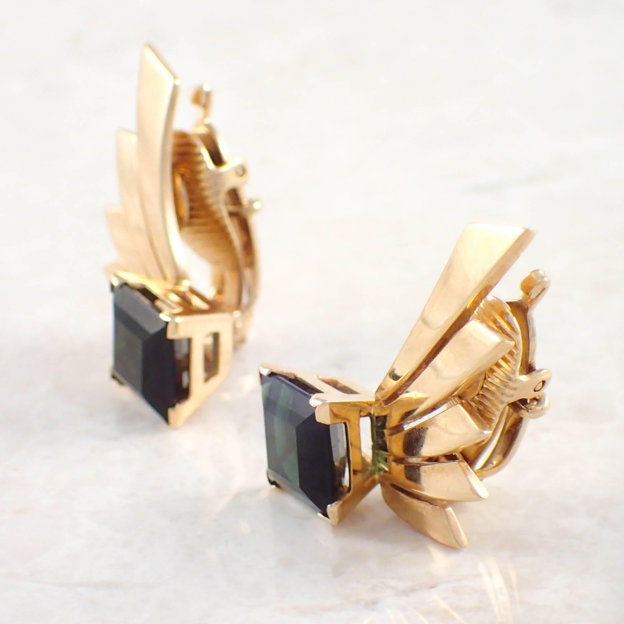 14K Yellow gold tourmaline Tiffany & Co. earrings.  The retro fan motif set with 2 green square cut tourmaline measuring 8.2 by 8.3 mm. Gold weight 10.7 grams. Stamp Tiffany & Co
Circa 1940s