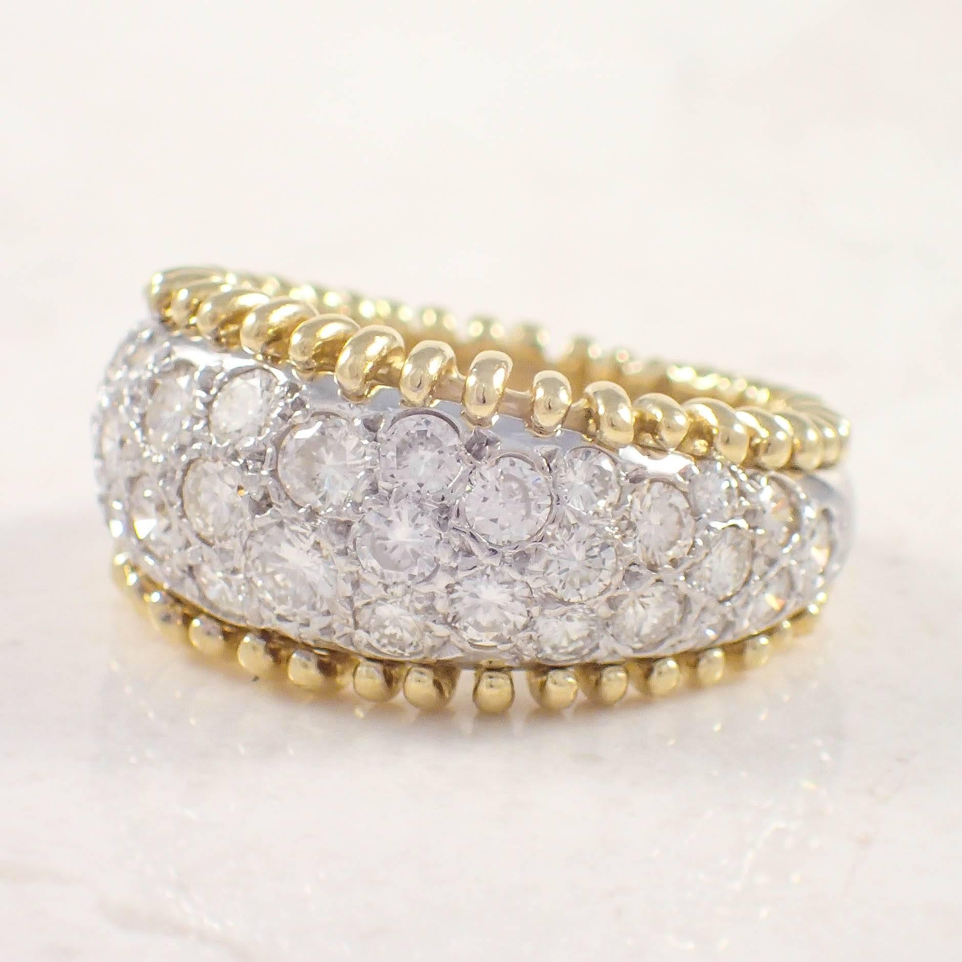18K Yellow and white gold diamond band. The domed band is pave set with 38 round diamonds weighing approximately 2.50 carats total. The band weighs 9.9 grams. 
Circa 1980s

Color: G-H
Clarity: SI 