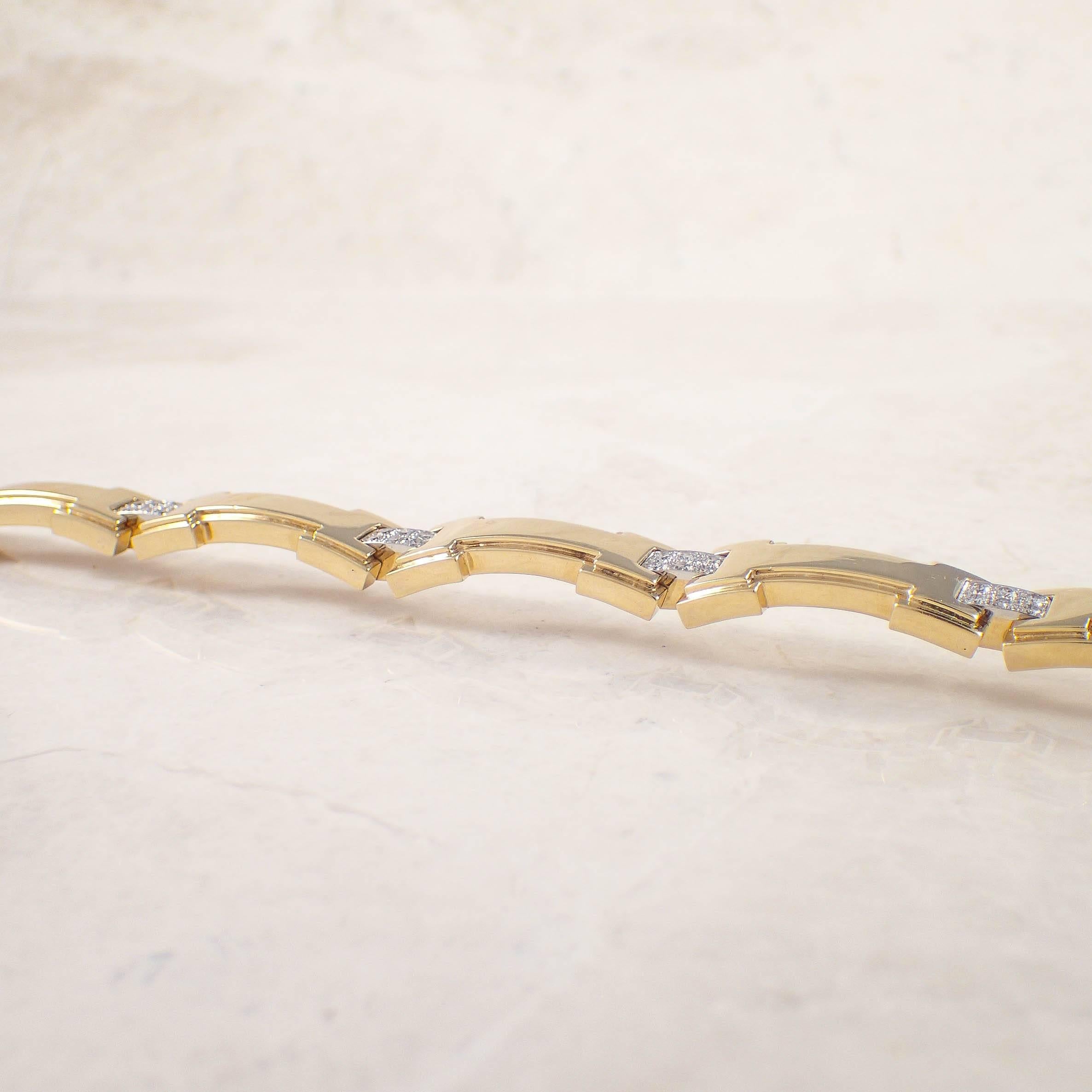 18K Yellow gold and platinum diamond David Webb bracelet. The flexible gold sections of the bracelet are alternated by platinum sections set with 36 small round diamonds weighing 2.00 carats total. The bracelet measures 11.5 mm X 7 inches and weighs