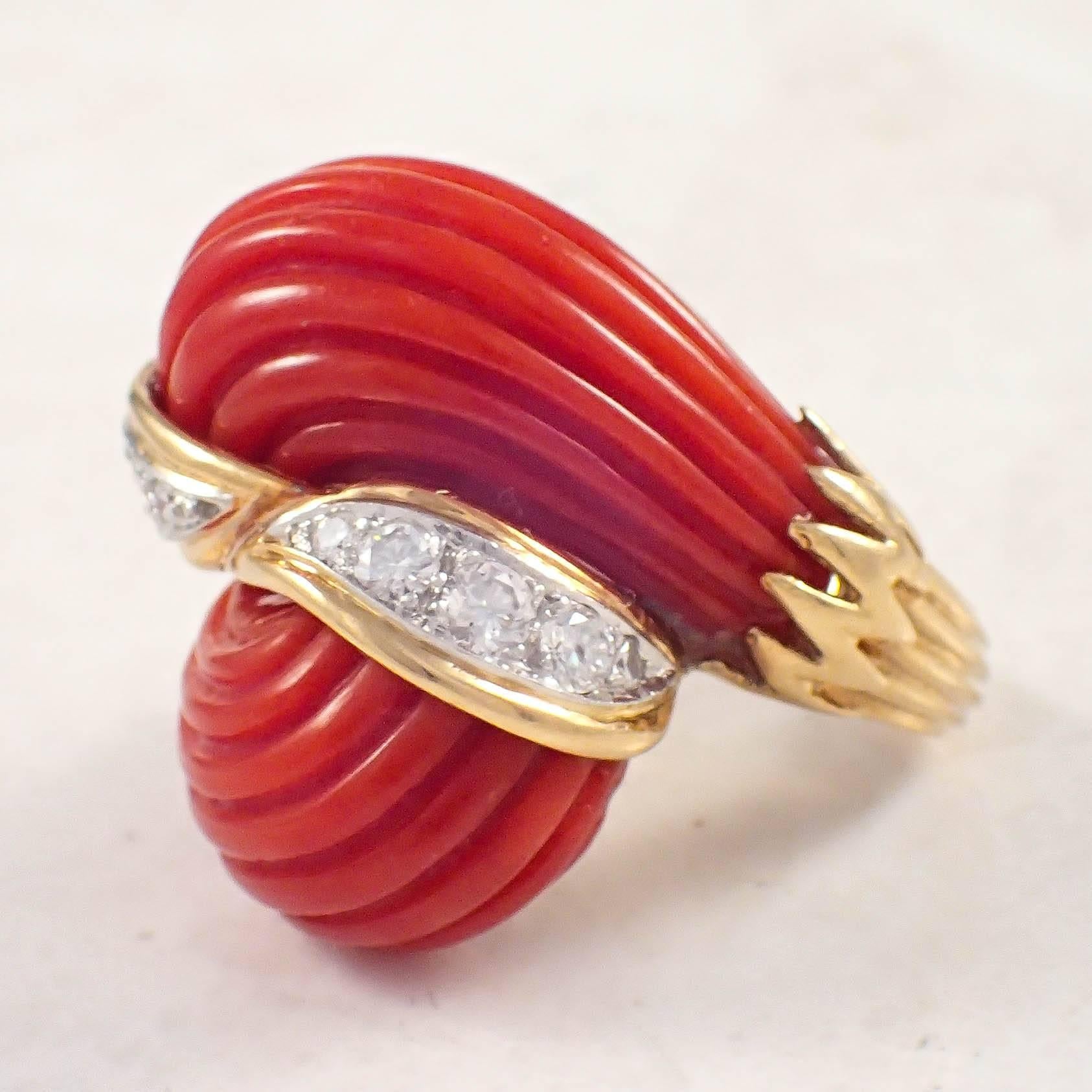 18K Yellow gold coral and diamond dome ring. The bypass dome ring is set with 2 carved oxblood coral pieces, and is set with 10 round diamonds weighing approximately .65 carat total. Gold weight 17.8 grams. 
Circa 1960s

Color: G-H
Clarity: VS-SI