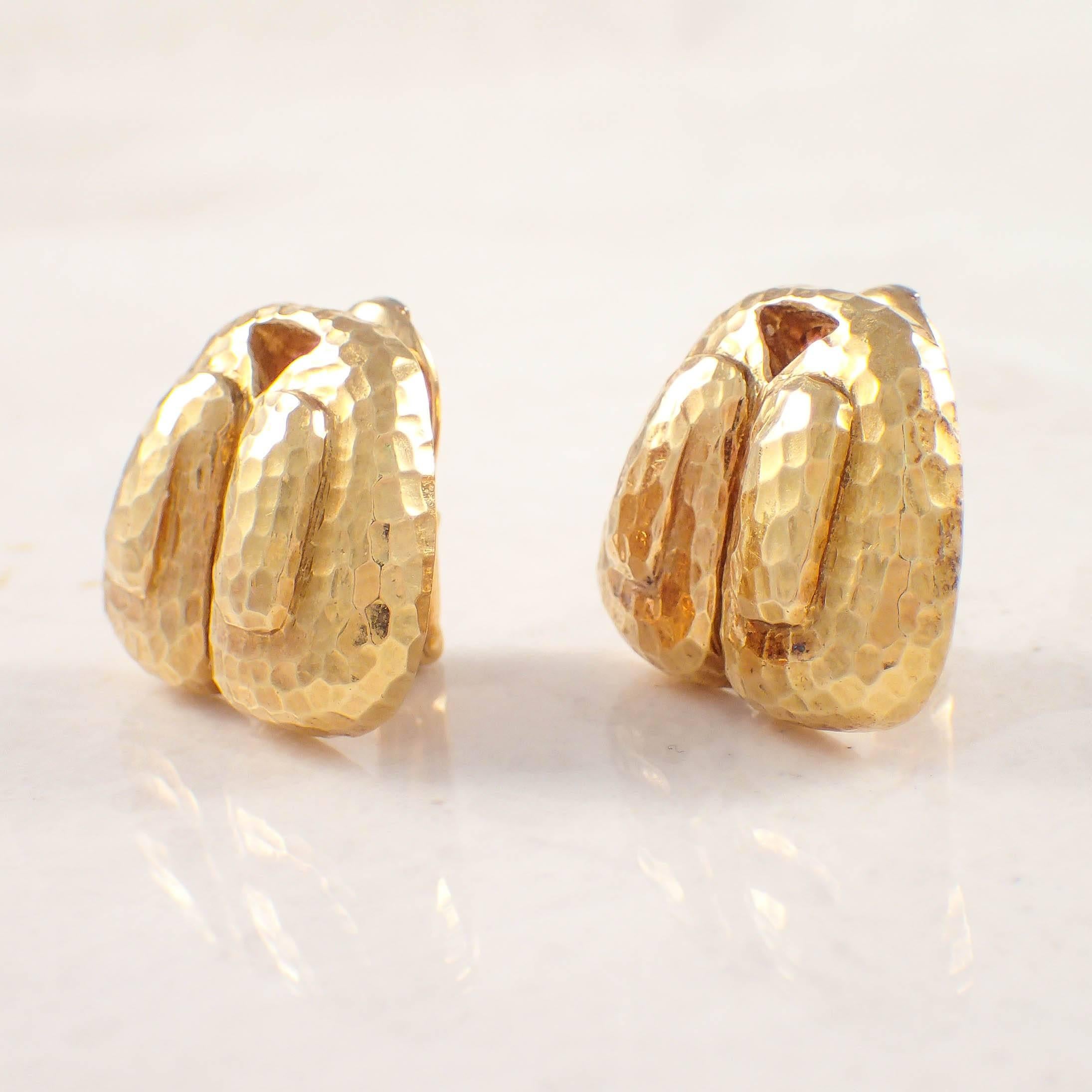 18K Yellow gold David Webb earrings. The hammered gold clip-on earrings measure 19.7 X 23.8 mm and weigh 21.9 grams. Stamped 