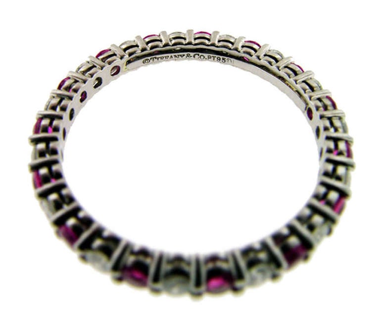 This beautiful pink sapphire and diamond band is set in platinum. Fifteen round pink sapphires alternate with 15 round brilliant cut diamonds. .45 cts. G colour and VS clarity, bead set with very fine workmanship. Measures size 6.5.
