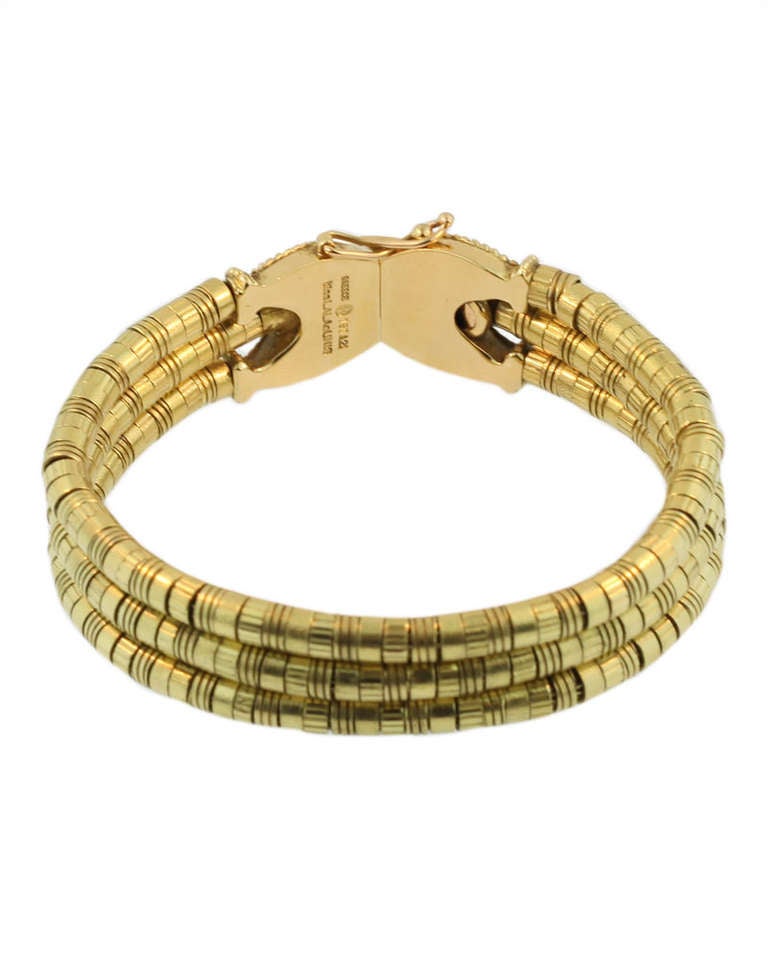This bracelet is inspired by designs from ancient Greece and is hand made in Athens by Ilias Lalalounis. It consists of three rows of deeply intense yellow golden roundels and is stamped 750, Greece and Ilias Lalaounis. The bracelet measures 7