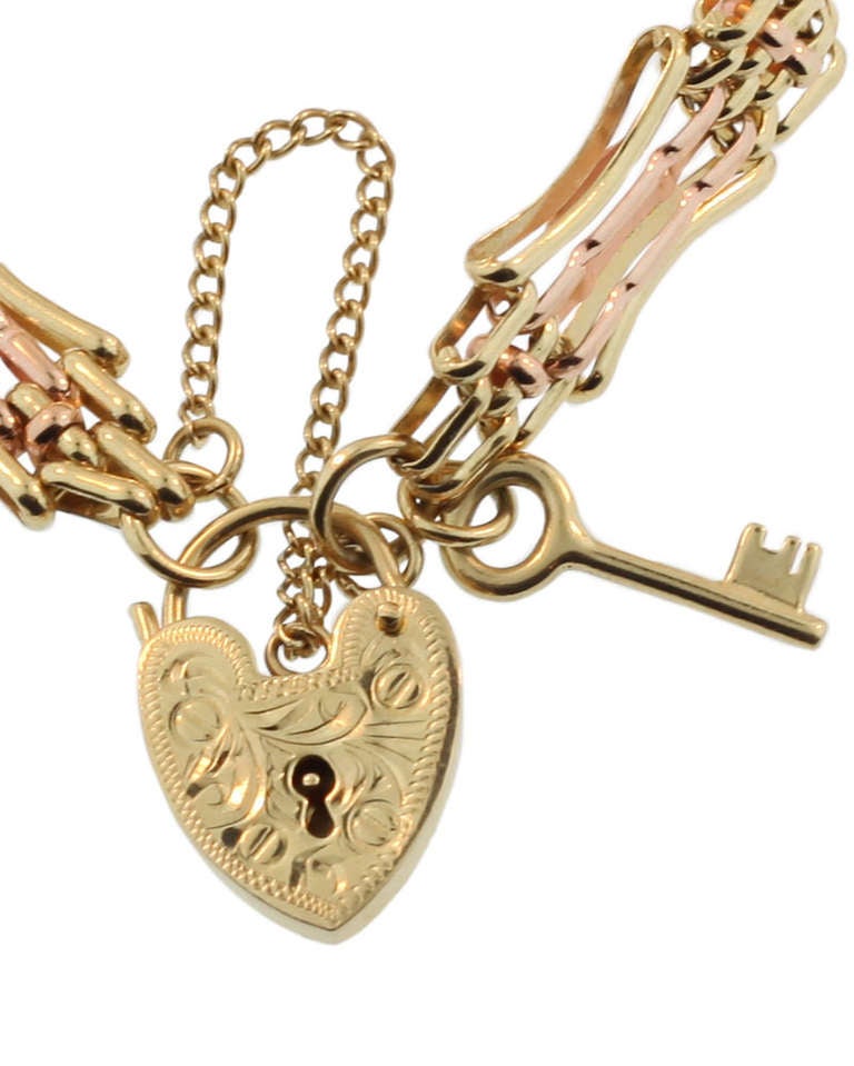 This charming bracelet has an intricate link produced in yellow and rose gold. It is clearly stamped 585. The bracelet is finished with a hand engraved heart lock and also has the little key which is somewhat rare. This piece is in excellent
