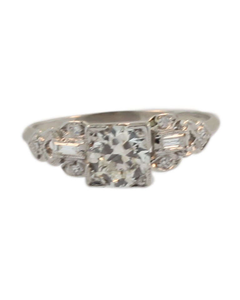 This art deco ring is set in platinum which has been tested. The central stone is old European cut and weighs .81 J colour VVS2 clarity. It is enhanced by two baguettes and six round single cut diamonds. The ring is a classic art deco original